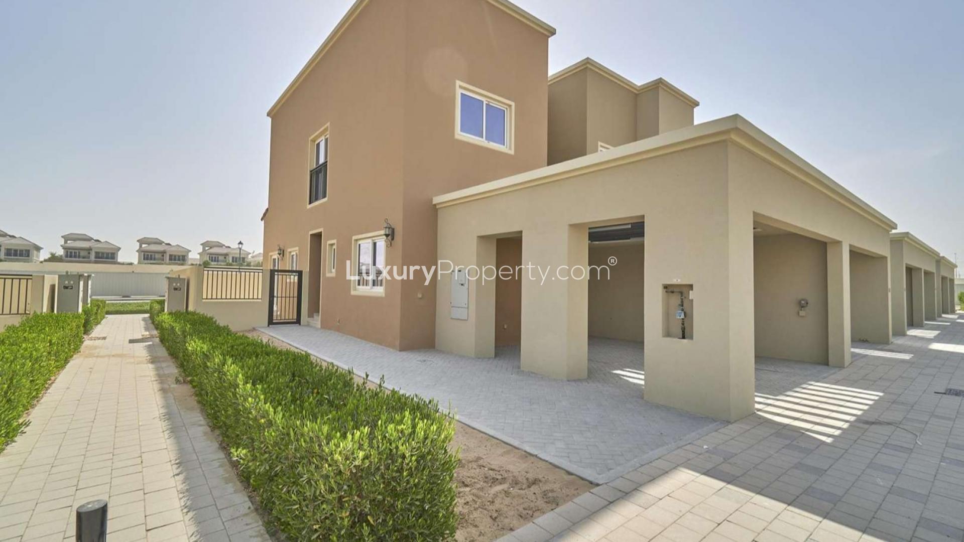 Bright living area with staircase and modern kitchen in Amaranta townhouse, Villanova, Dubai Land