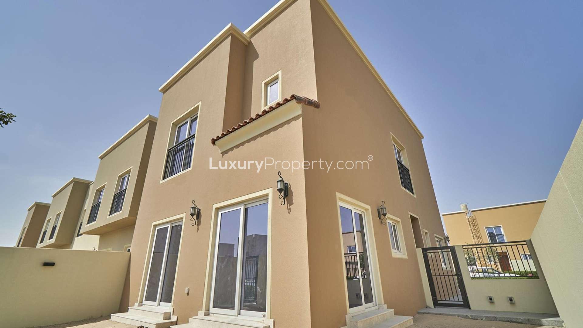 Bright living room with large windows in Villanova townhouse, Dubai Land, for sale