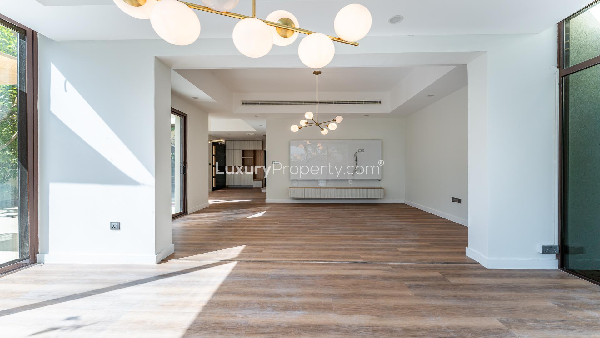 Bright living room in Mira townhouse, wooden flooring, large windows, modern chandelier, Reem community