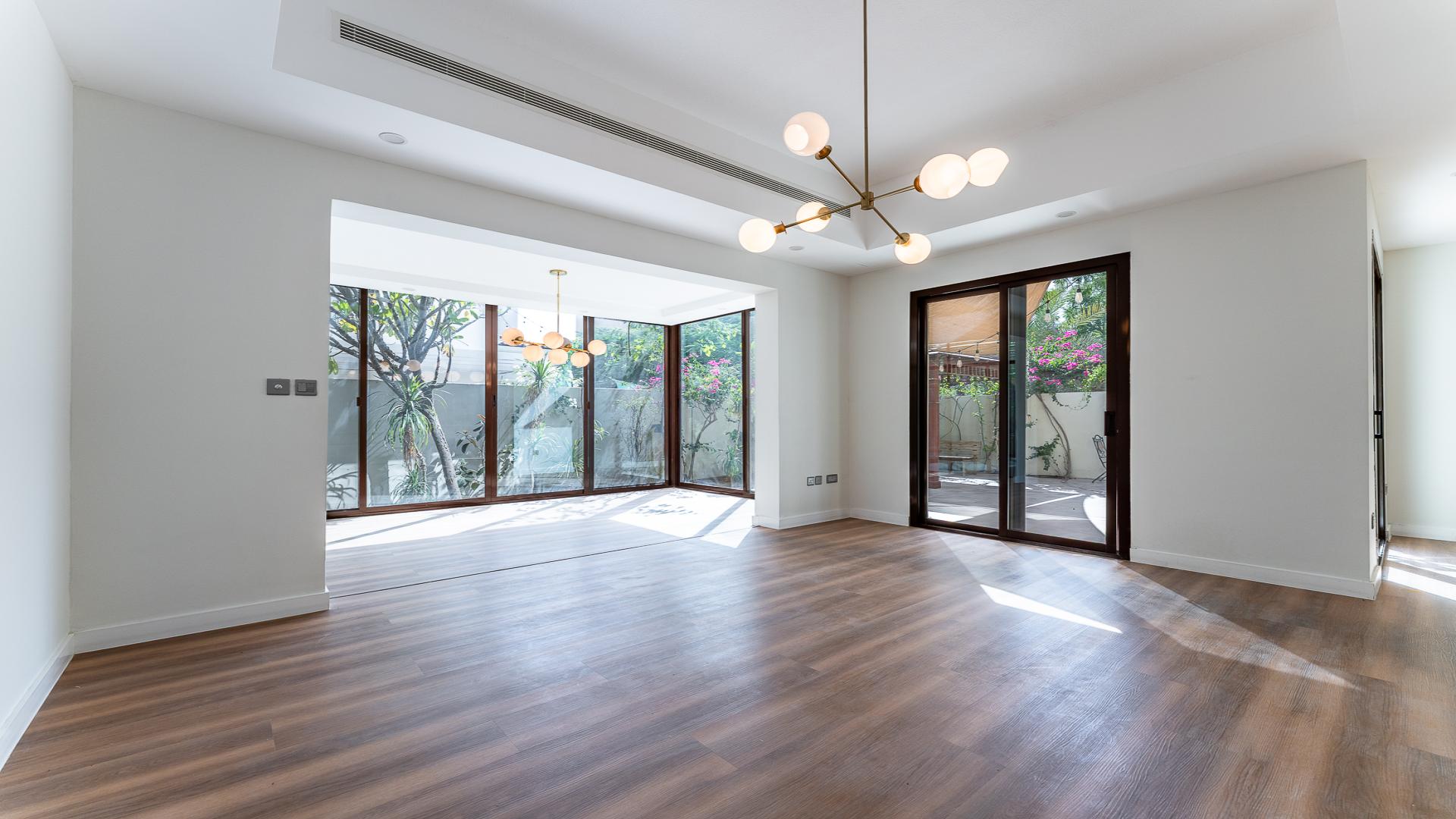 Spacious living area in Mira townhouse, Reem community, featuring large windows and modern lighting