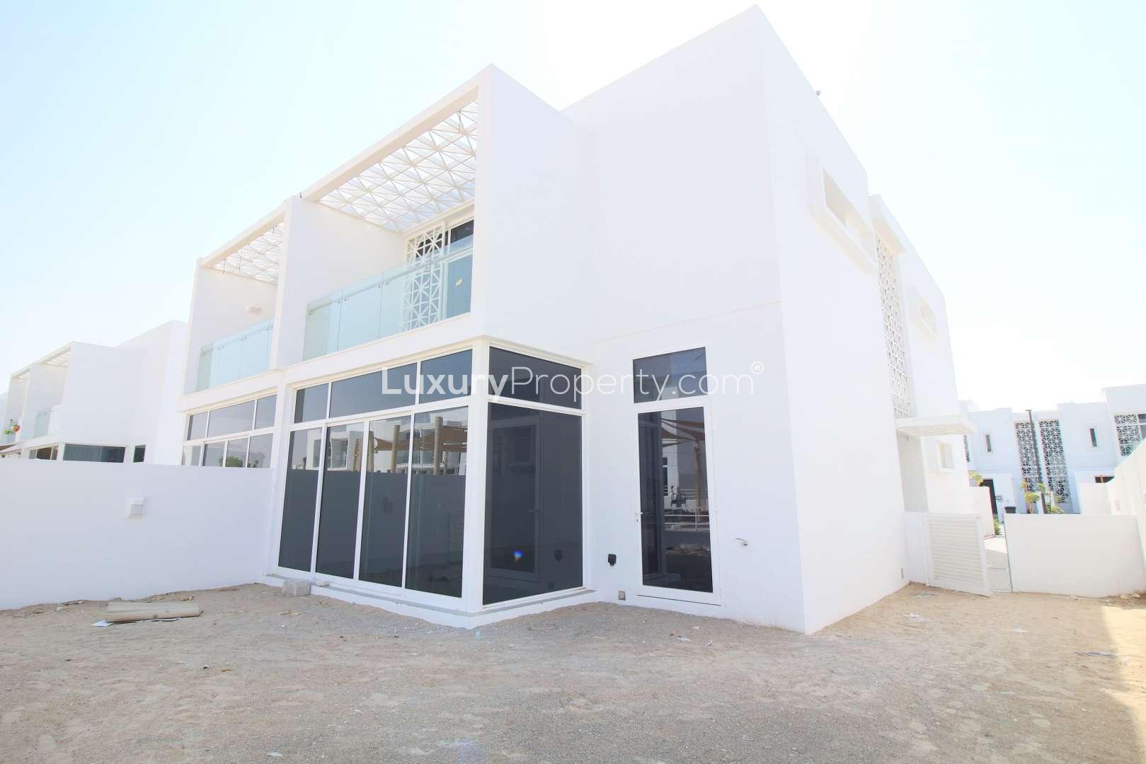 Stunning 4-bedroom villa exterior in Arabella Townhouses, Mudon, with modern design and park views