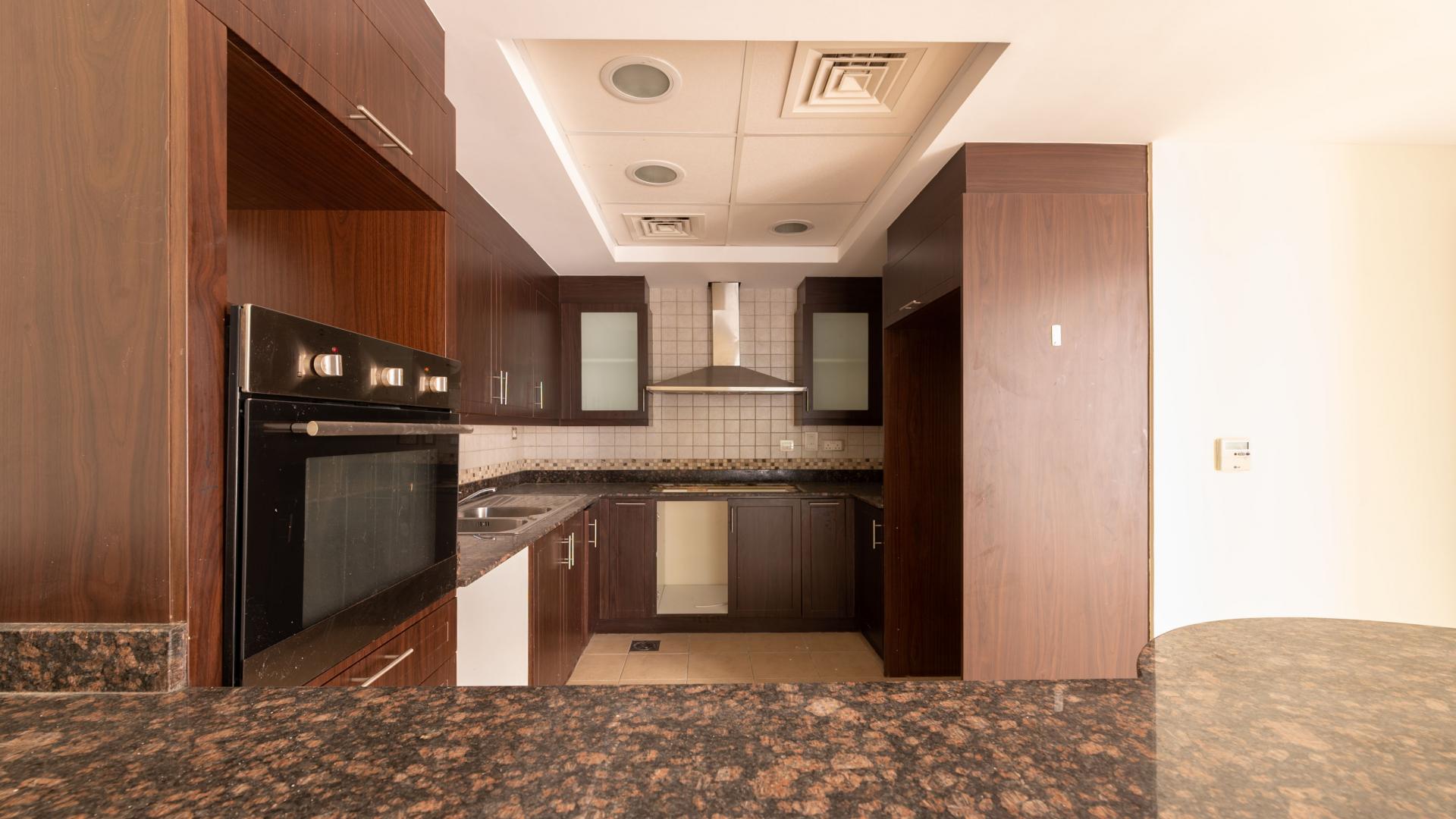 Open-plan kitchen and living area in upgraded Mudon townhouse, featuring large sliding glass doors