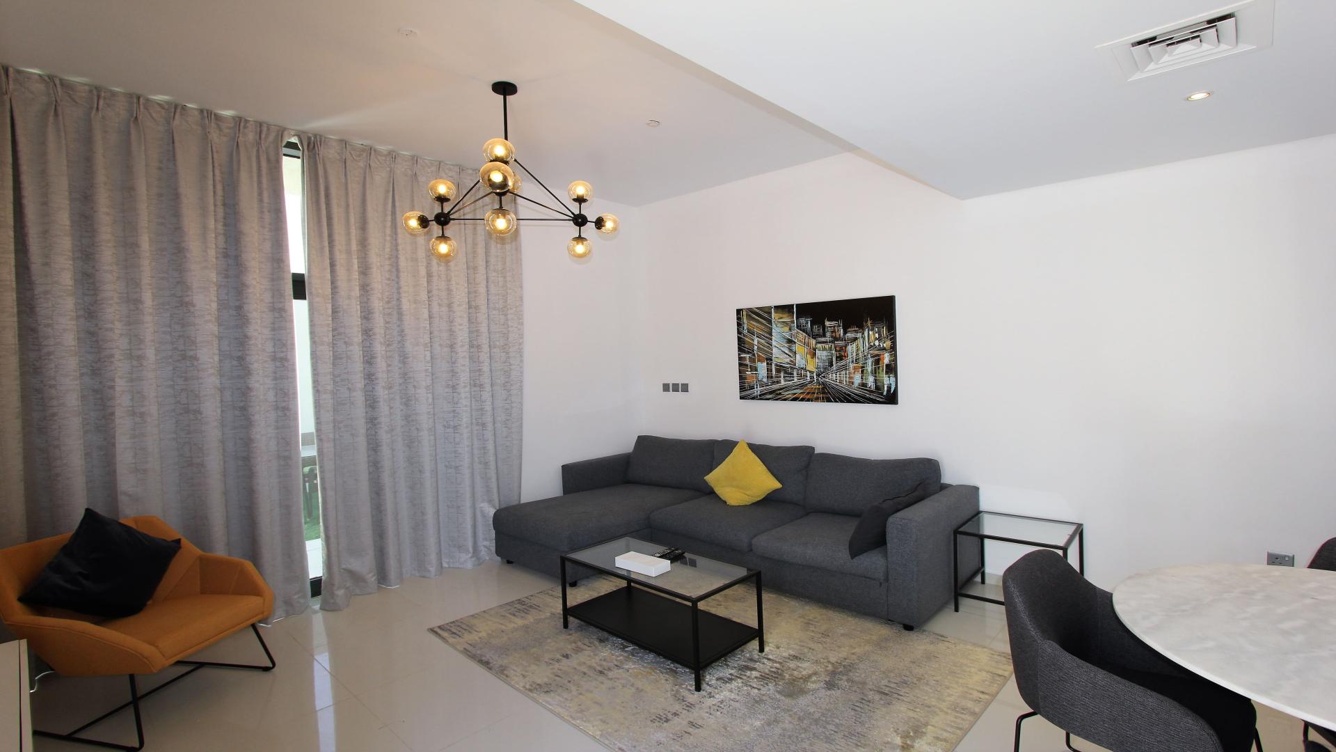 Outdoor patio with seating at 3-bedroom townhouse in Amazonia, Damac Hills 2