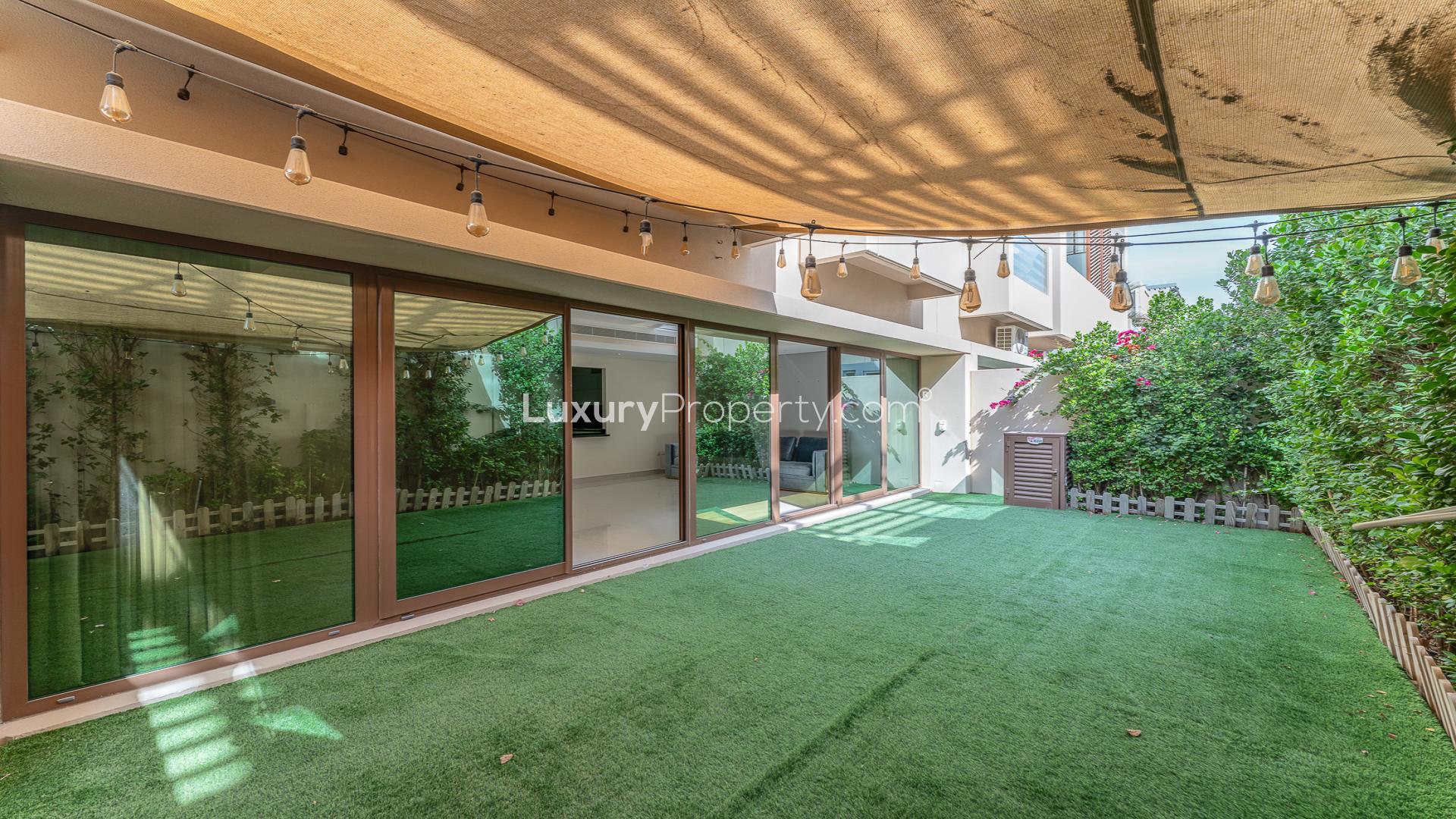 Townhouse rooftop view of Burj Khalifa at night in Meydan's Grand Views community