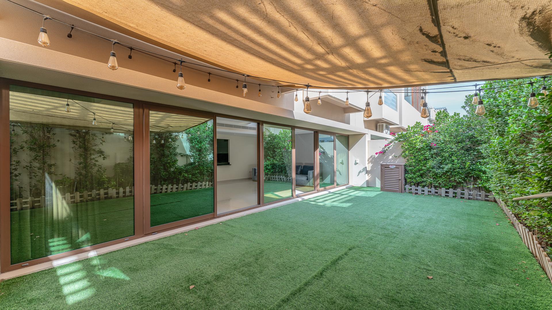 Townhouse rooftop view of Burj Khalifa at night in Meydan's Grand Views community