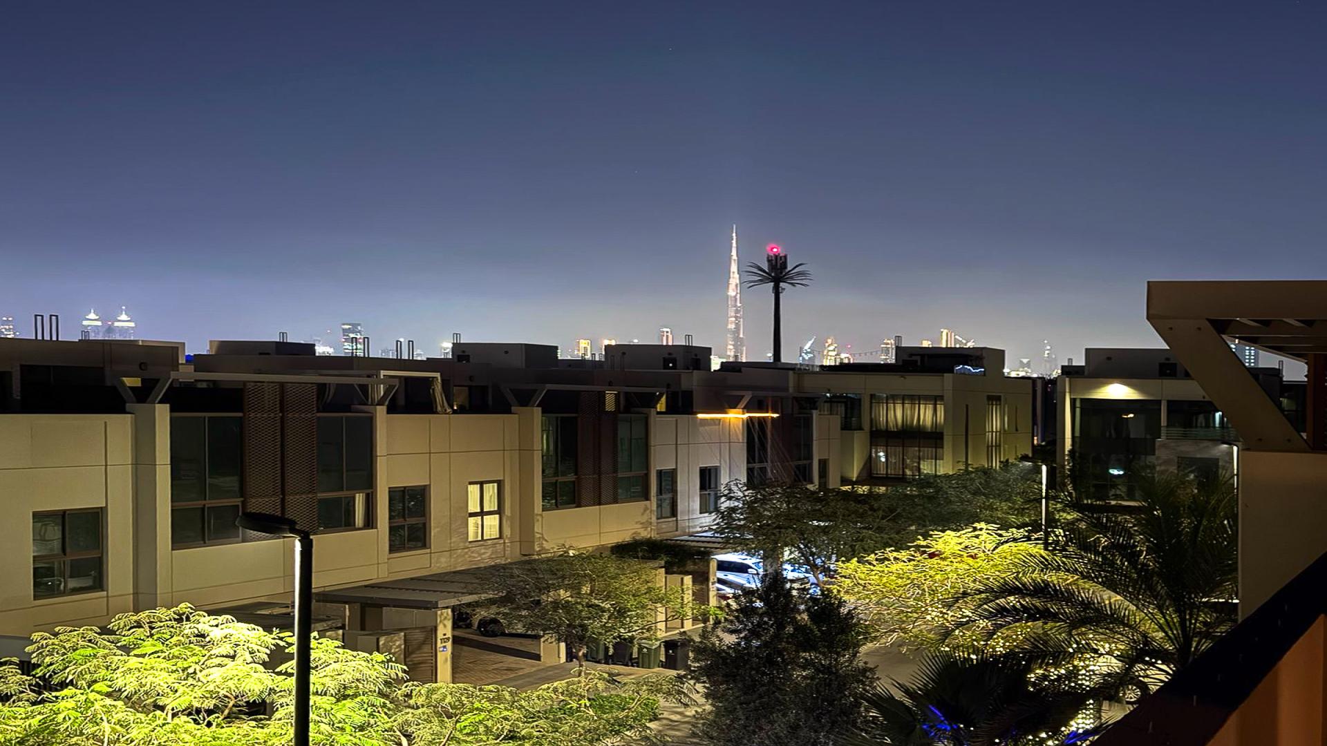 Spacious living room with large windows in Meydan townhouse, Grand Views community