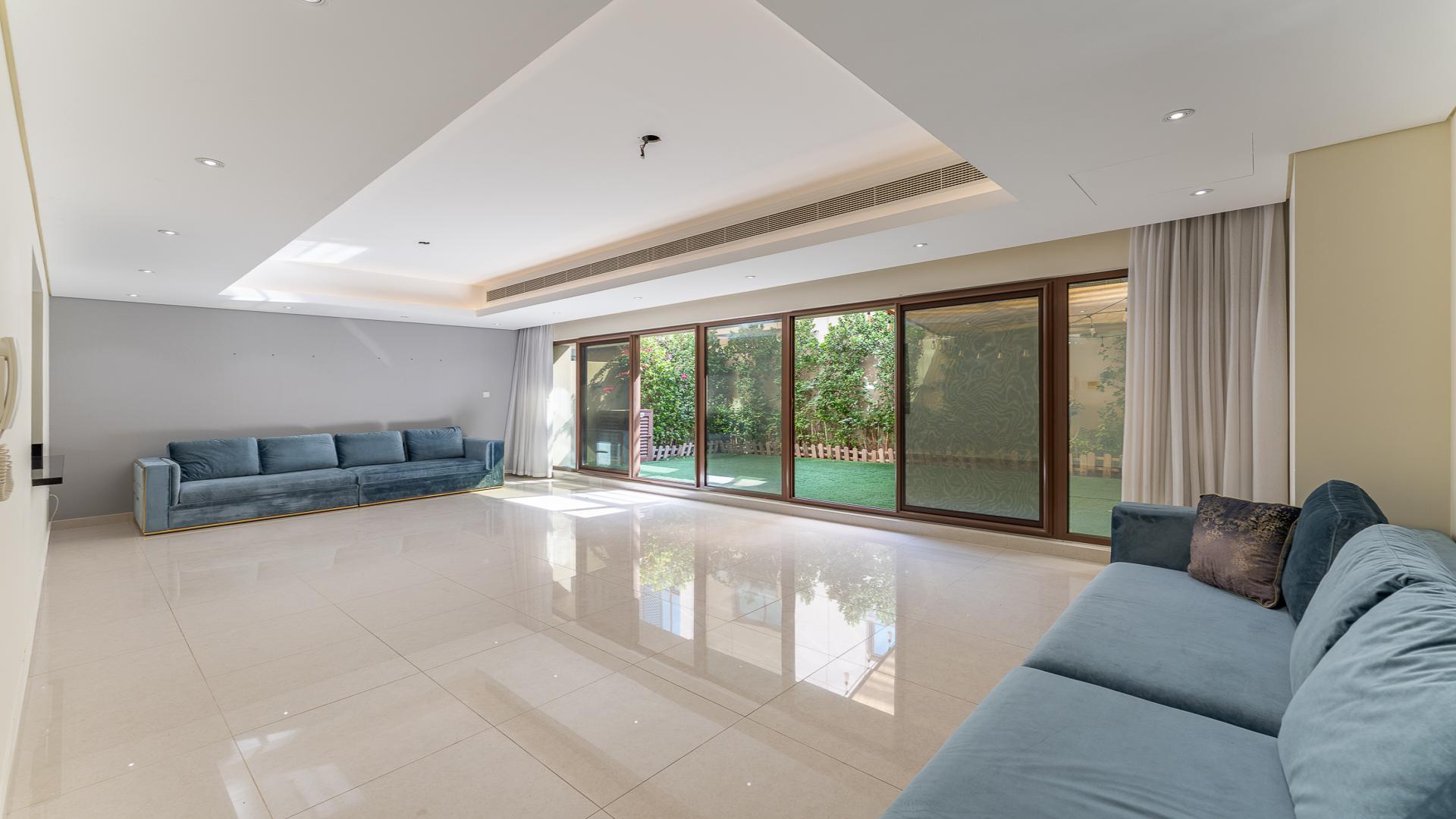 Townhouse exterior in Meydan's Grand Views community, showcasing modern architecture and spacious driveway