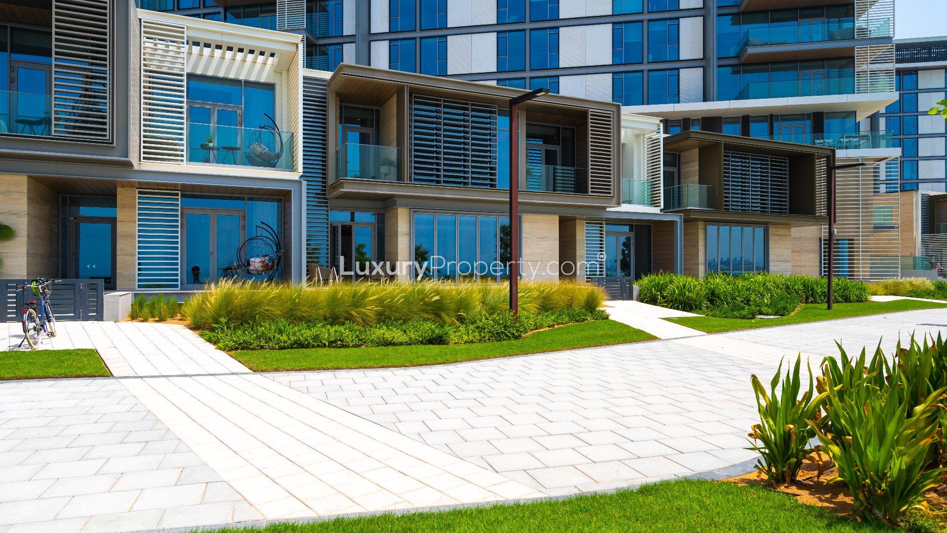 Modern bathroom with dual sinks and bathtub in Bluewaters townhouse for sale