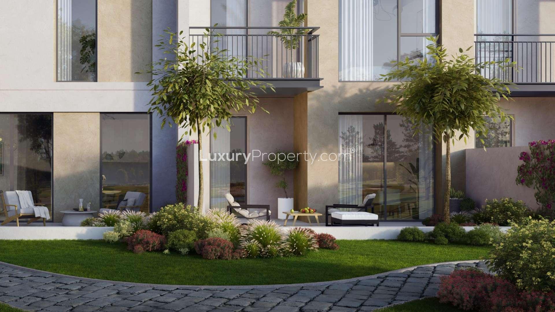 Modern interior decor with potted plant and clothes rack in Arabian Ranches 2 townhouse