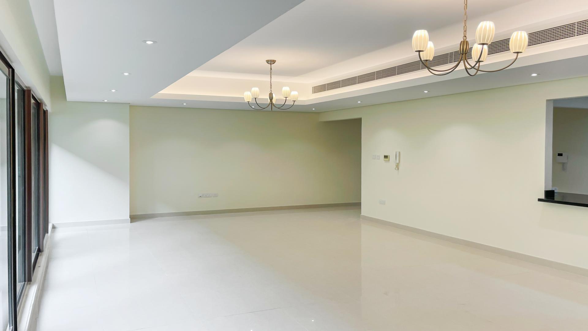 Spacious living room in Meydan townhouse with modern lighting and large windows