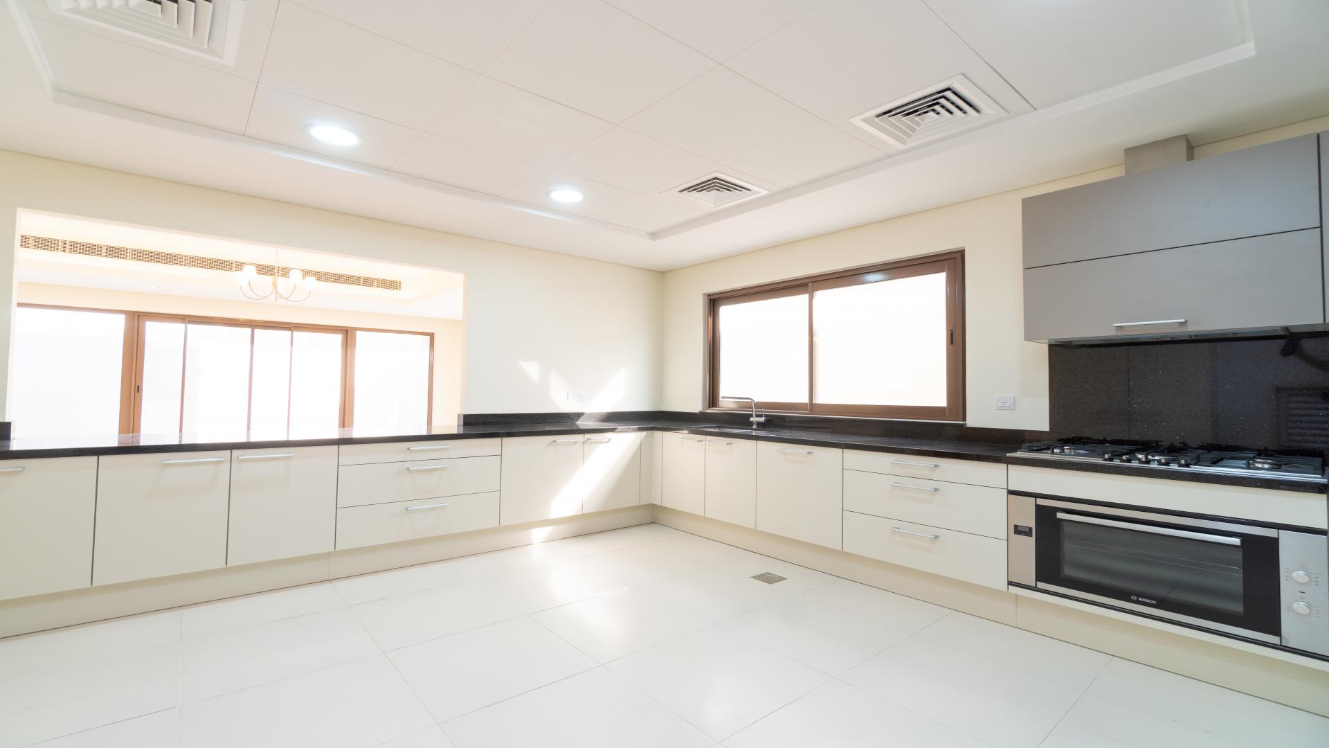 Spacious living area in Meydan townhouse with large windows and elegant lighting fixtures