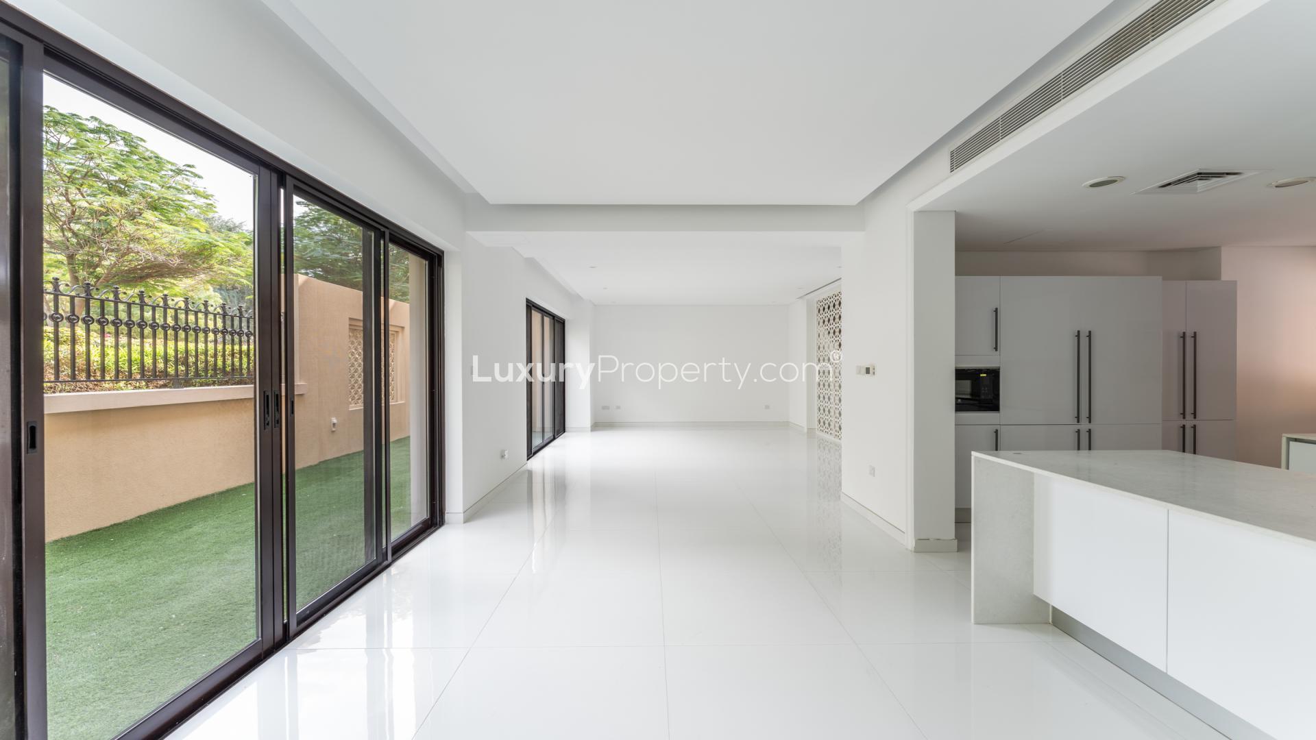 Elegant 4-bedroom townhouse for sale in Bloomingdale, Dubai Sports City, with palm trees