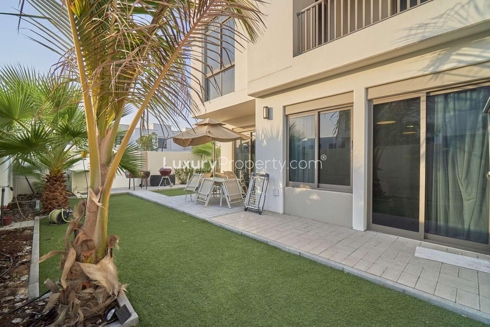 Dining area in 4-bedroom townhouse, Hayat Town Square, with wooden table and glass cabinet