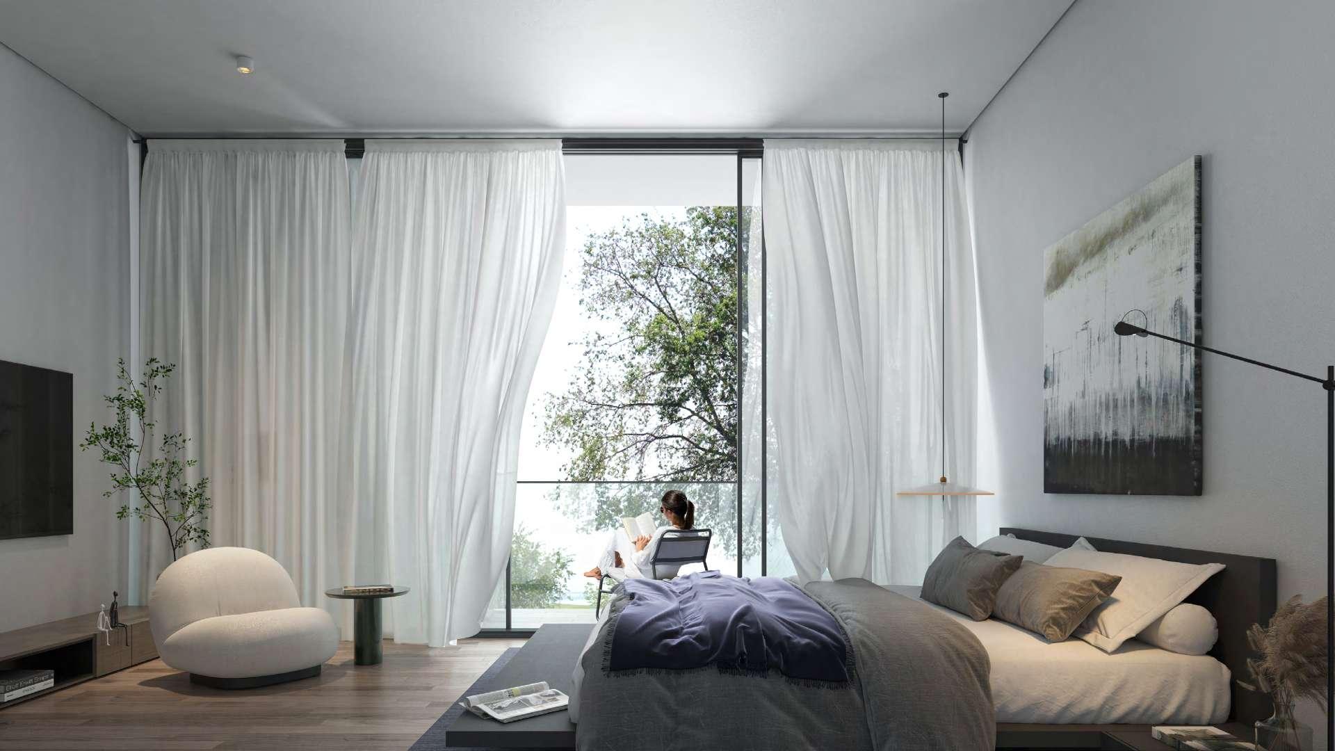 Modern living room in Type A townhouse, Jouri Hills, with garden view through large windows