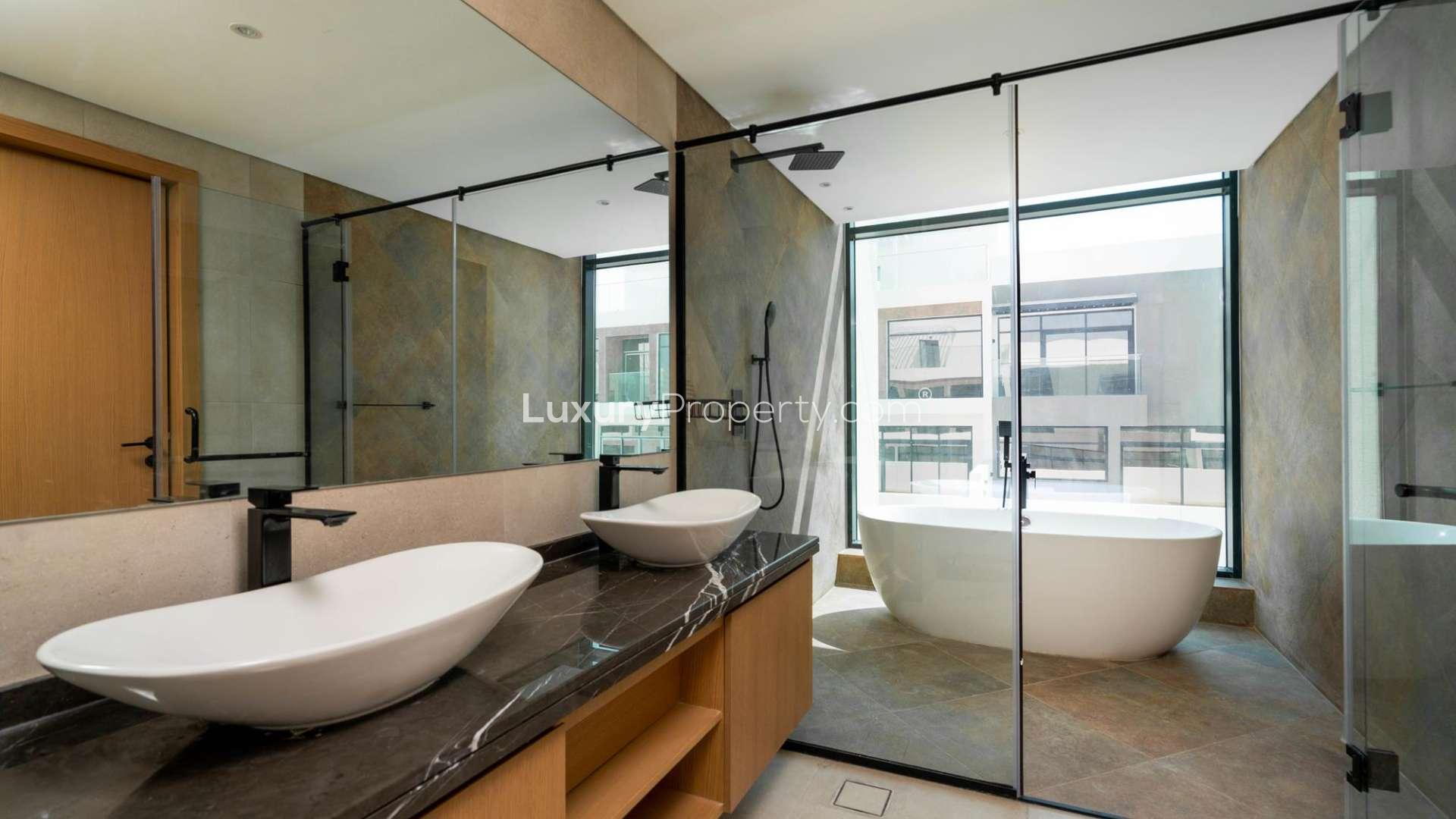 Bright empty room with large window view in Jumeirah Golf Estates townhouse