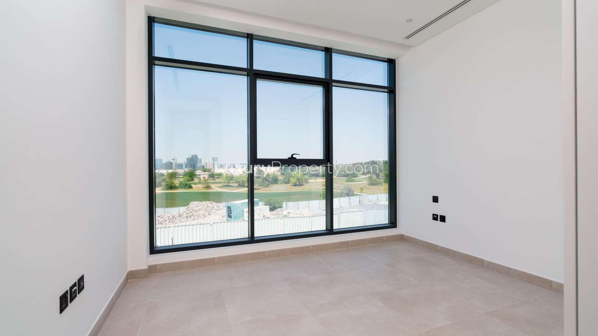 Modern kitchen in Jumeirah Luxury townhouse, featuring sleek cabinetry and large window views
