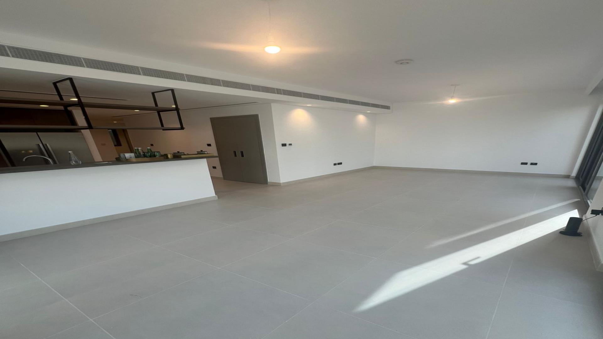 Modern kitchen in Aura Gardens townhouse, Tilal Al Ghaf, spacious layout with sleek finishes