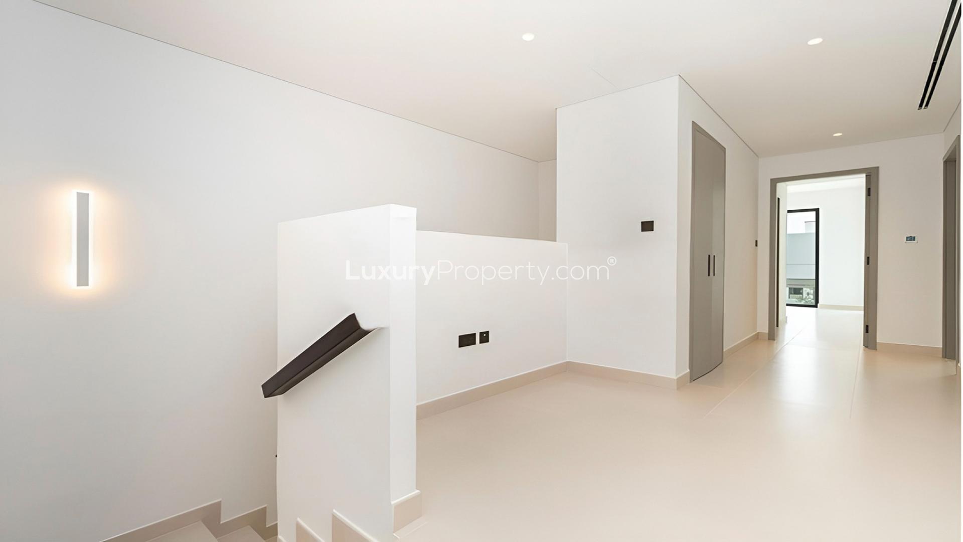 End unit townhouse exterior in Aura Gardens, Tilal Al Ghaf, with spacious backyard area