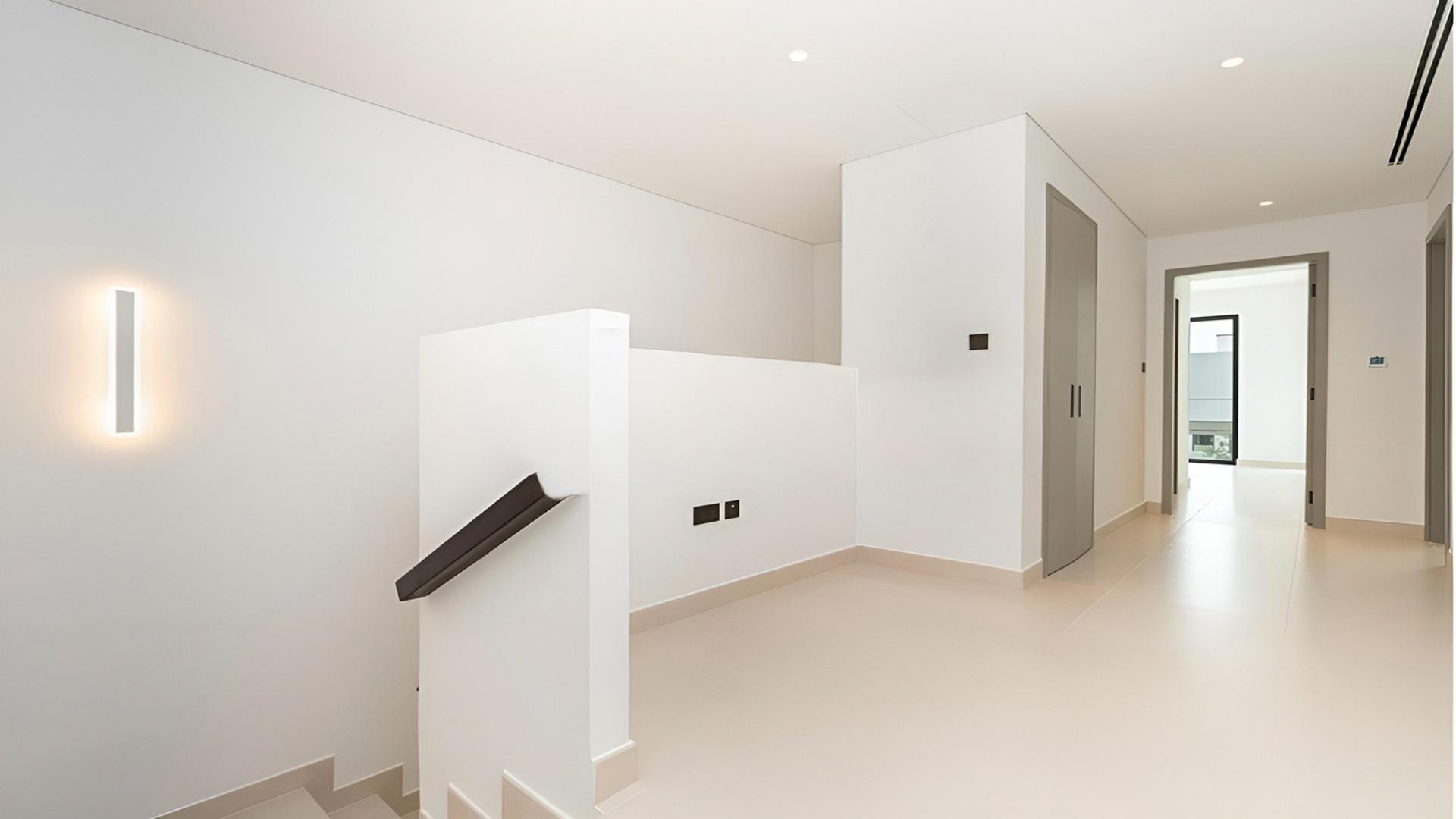 End unit townhouse exterior in Aura Gardens, Tilal Al Ghaf, with spacious backyard area