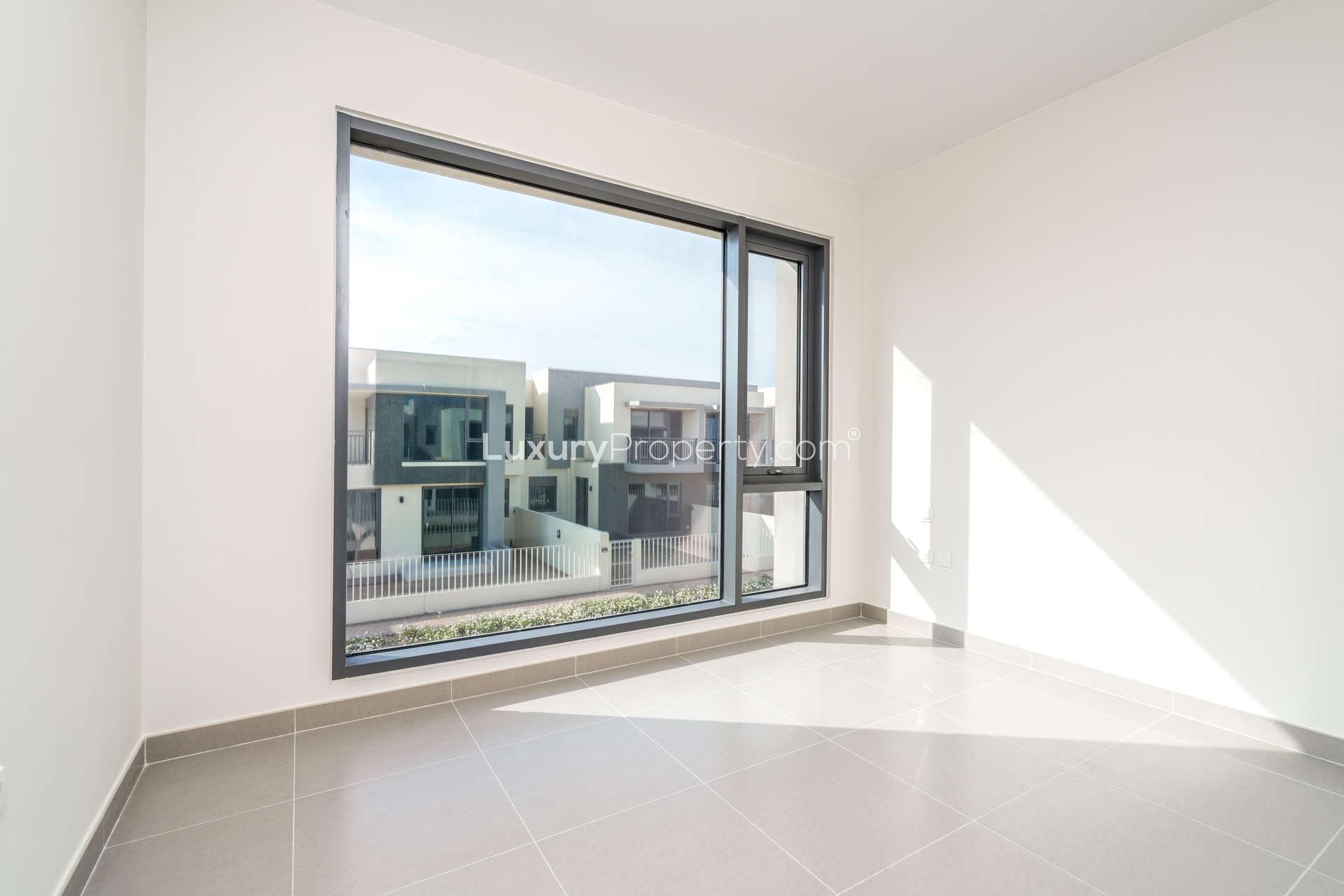 Interior view of townhouse hallway with large windows in Dubai Hills Estate