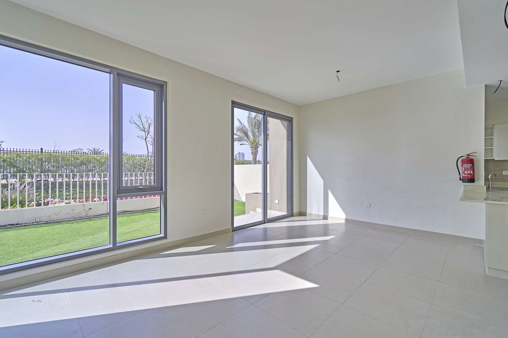 "Spacious backyard of four-bedroom villa in Maple 2, Dubai Hills Estate for sale.",Bright living area in four-bedroom villa, Maple 2, Dubai Hills Estate with garden view