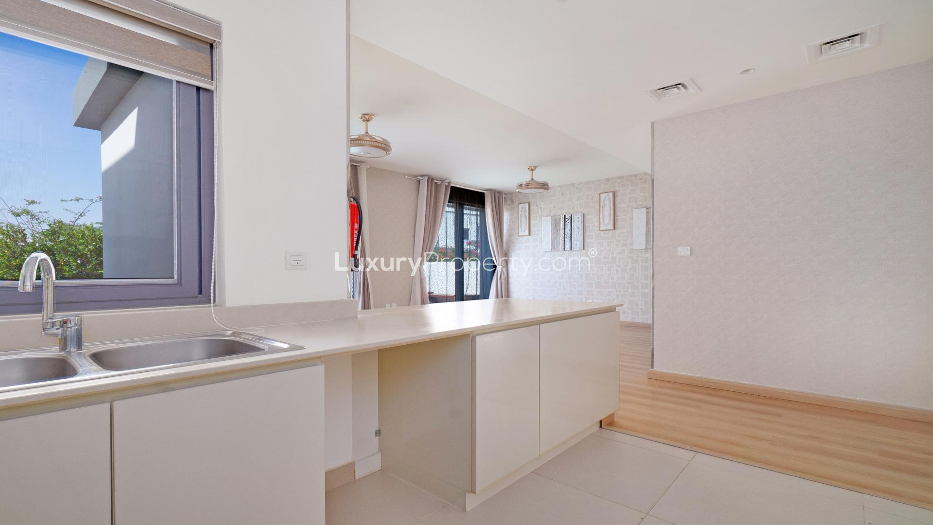 Modern kitchen in 4-bedroom townhouse, Maple at Dubai Hills Estate, with sleek white cabinets