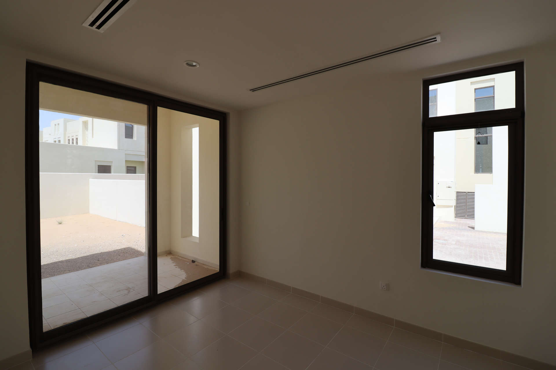 Empty room with large window in elegant 4-bed townhouse, Mira Oasis, Reem