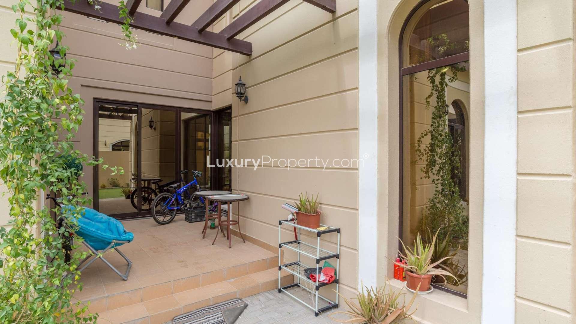 Elegant 4-bedroom townhouse exterior in Al Naseem, Mudon with garage and lush landscaping