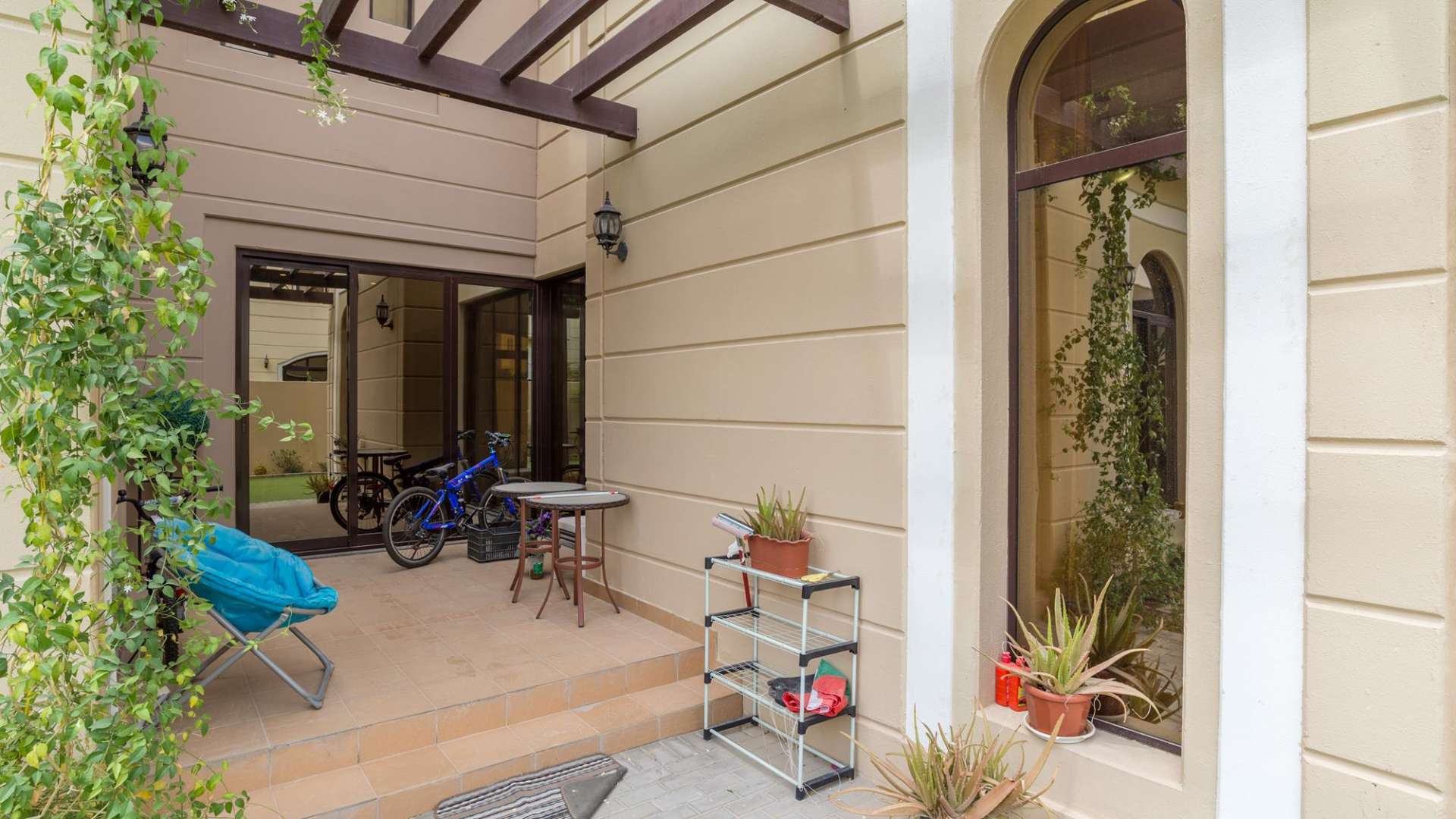 Elegant 4-bedroom townhouse exterior in Al Naseem, Mudon with garage and lush landscaping