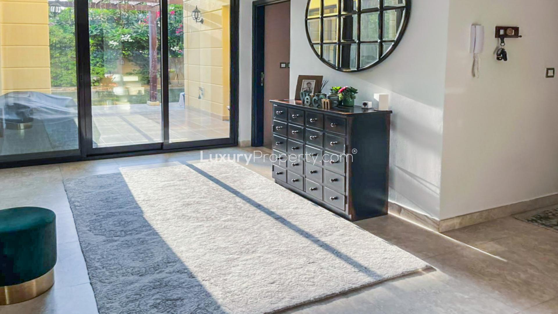 "Elegant townhouse entryway with staircase, modern decor in Naseem, Mudon, LP15066 for sale.",Bright entryway in upgraded Mudon townhouse with garden view through glass doors