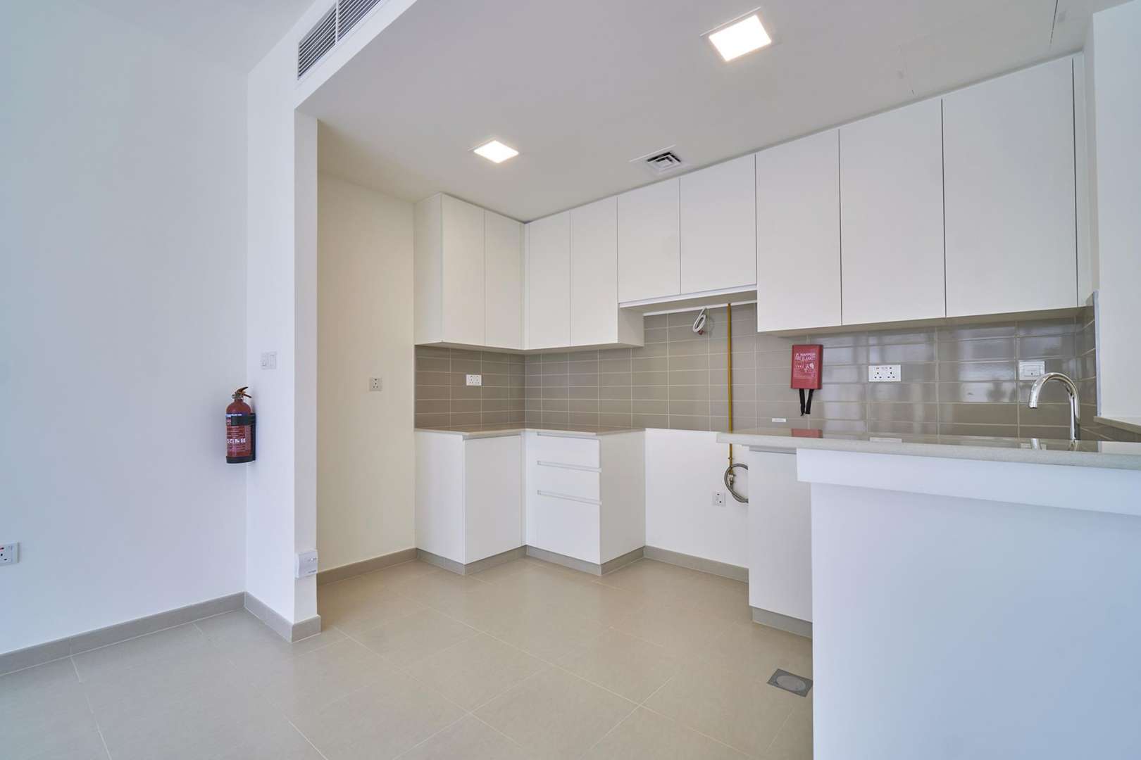 Brand-new 4-bedroom townhouse kitchen and living area in Naseem, Town Square for sale