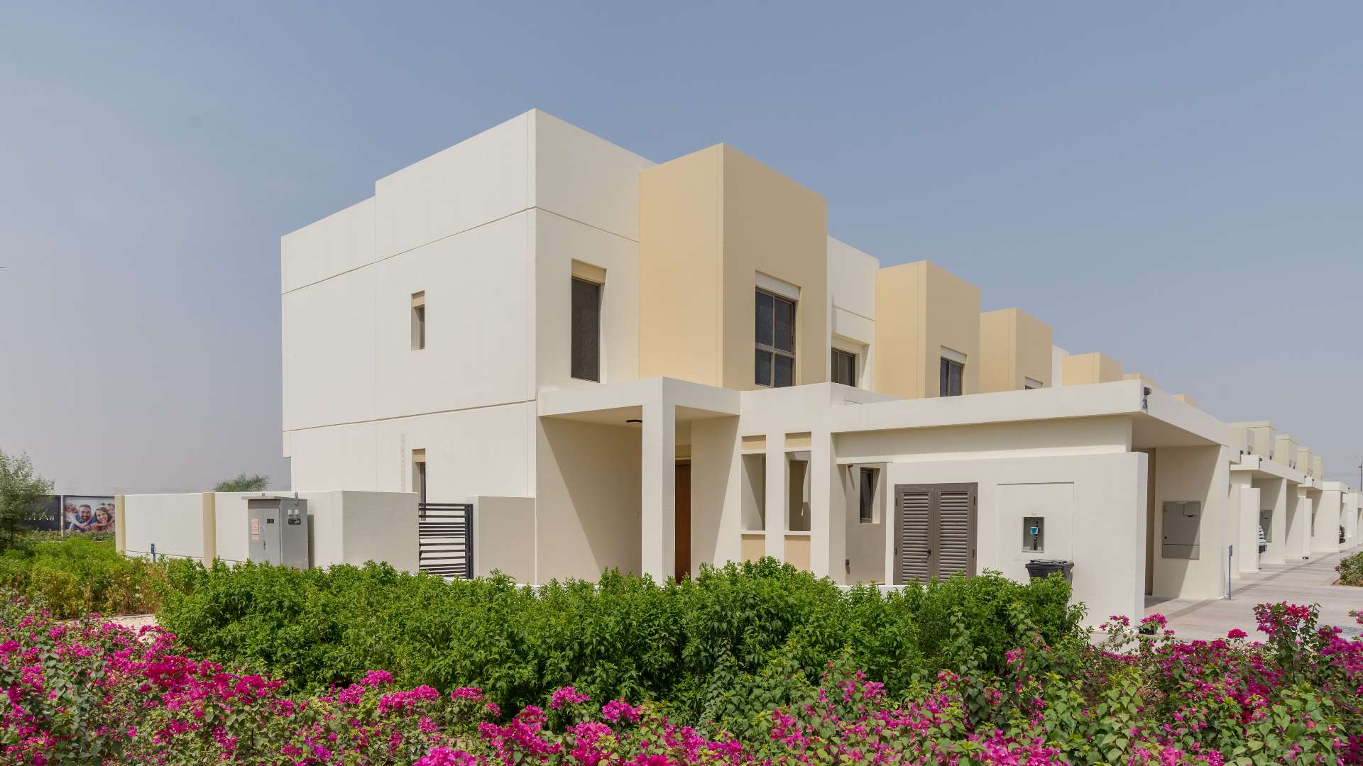 Front view of four-bedroom townhouse for sale in Naseem, Town Square with carport