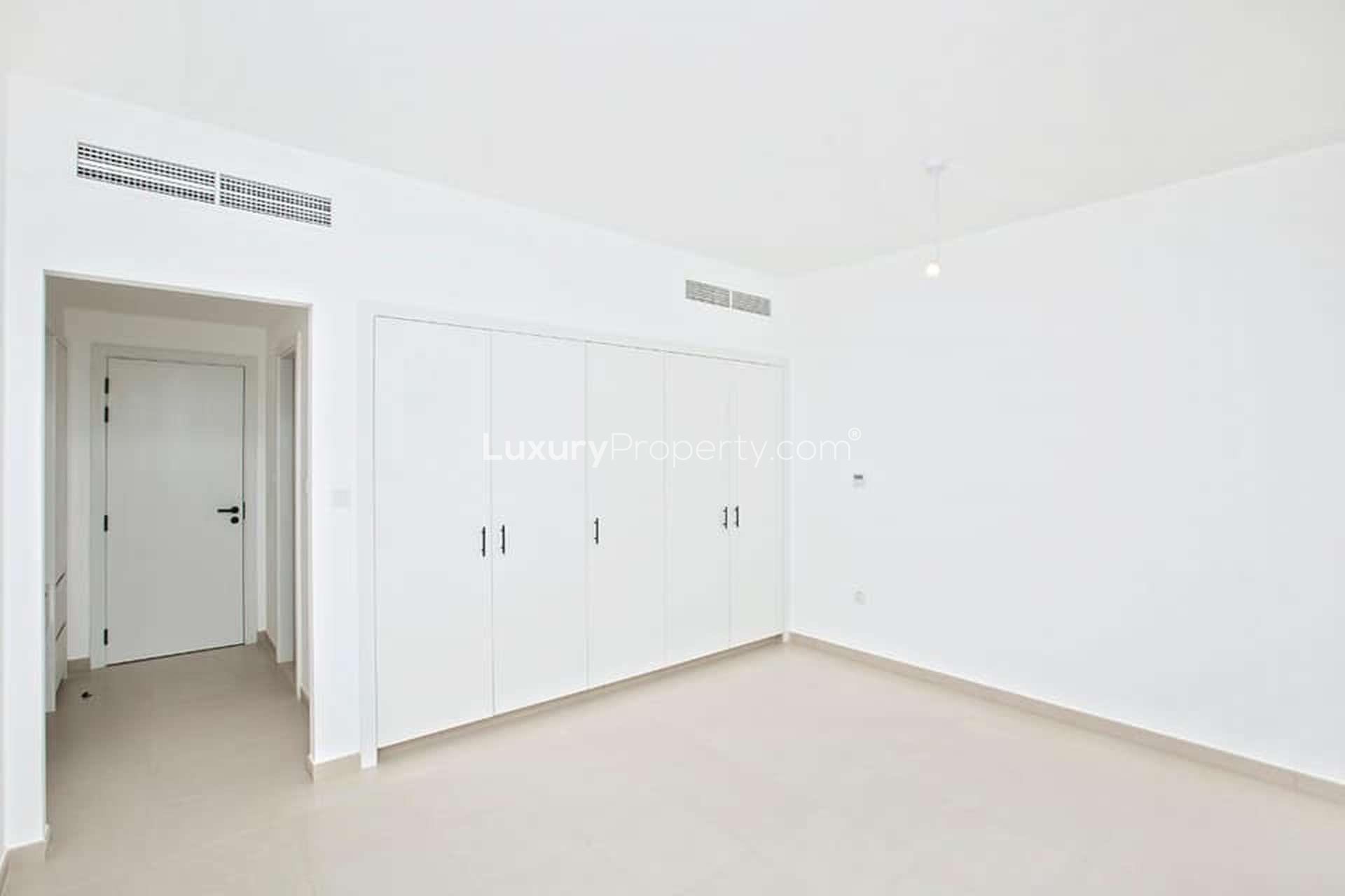 "Bright bedroom with built-in wardrobe in Noor Town Square townhouse for sale.",Brand new 4-bedroom townhouse interior, spacious room with built-in wardrobes, Noor Town Square