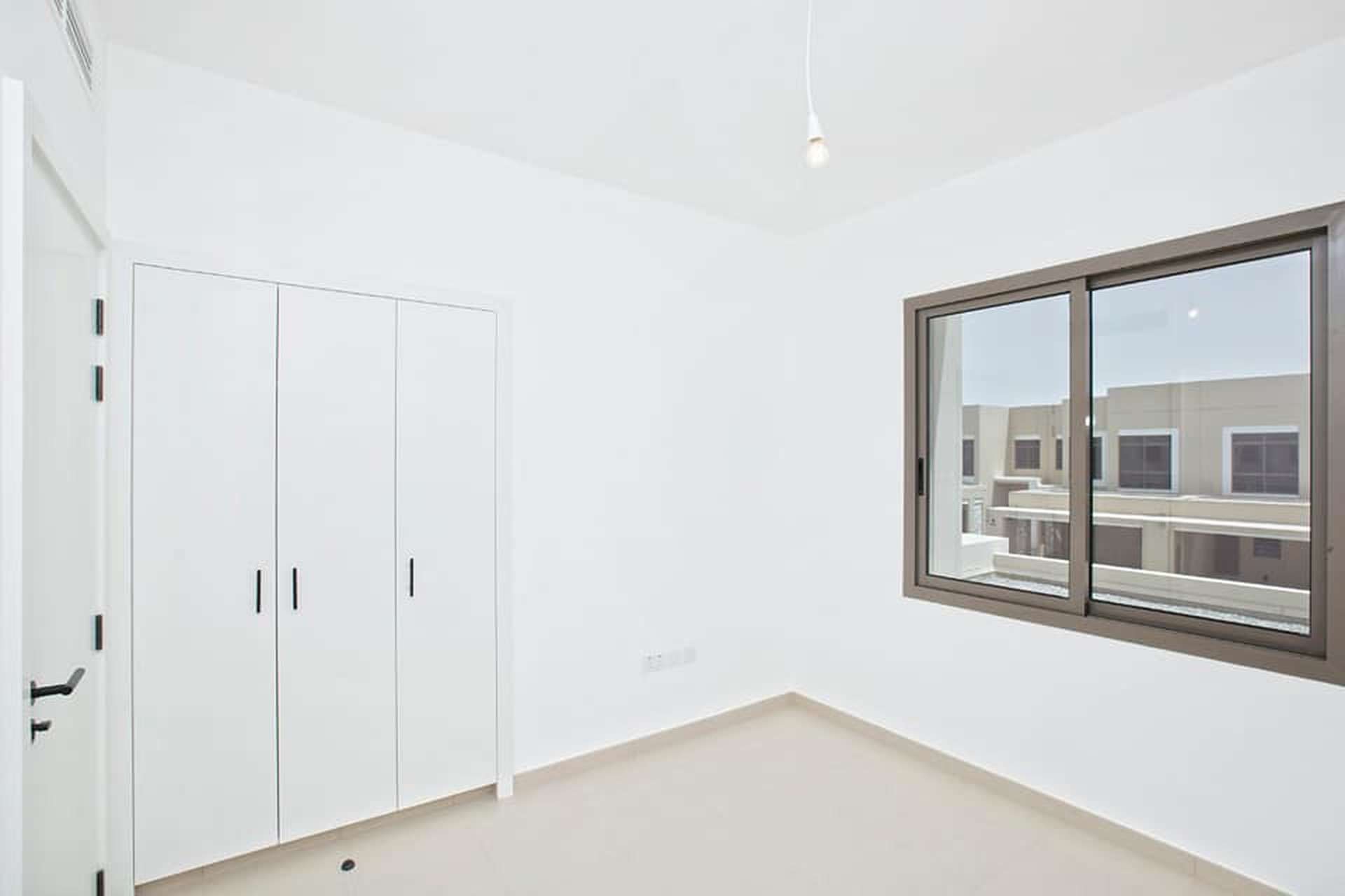 Brand new 4-bedroom townhouse interior with large windows in Noor, Town Square
