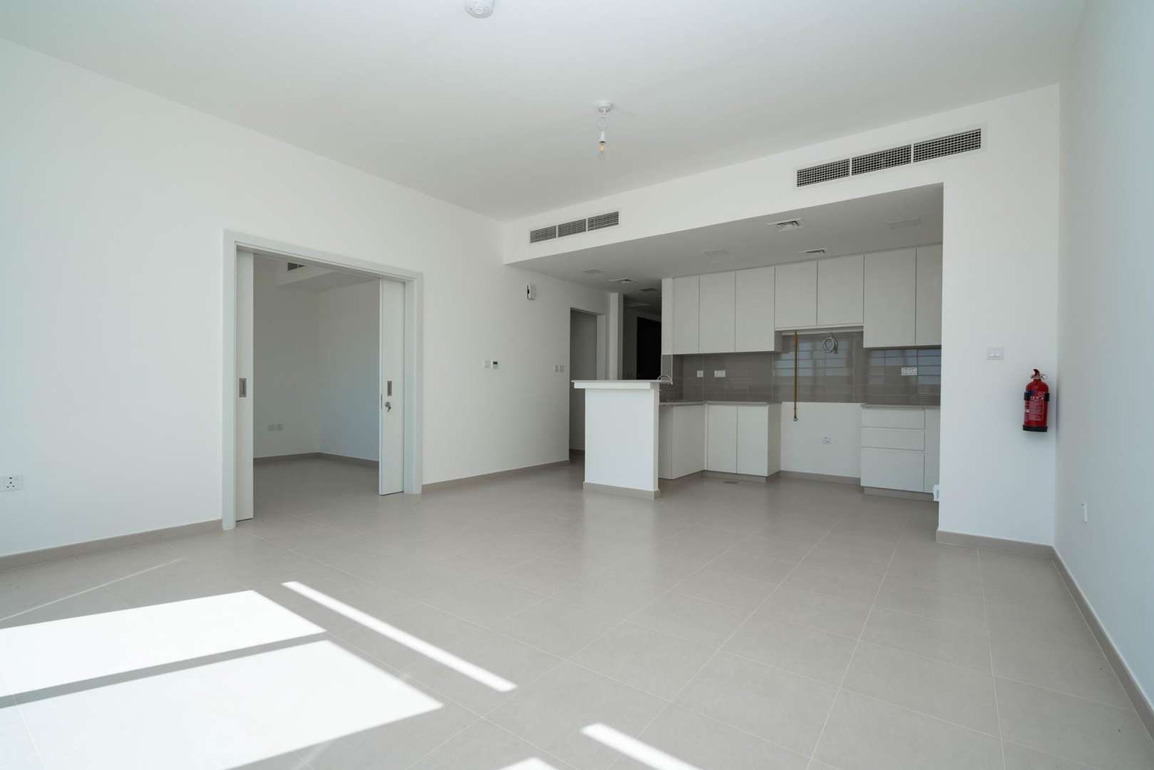 Bright open-plan kitchen and living area in Noor Town Square townhouse for sale