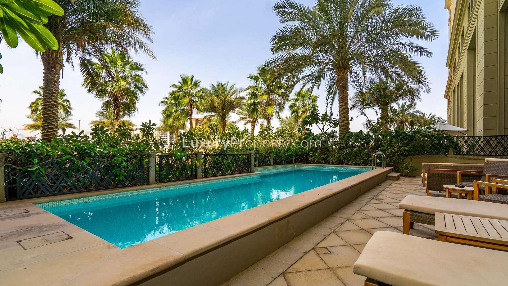 Outdoor pool and lounge area at Palazzo Versace townhouse, Culture Village, for sale
