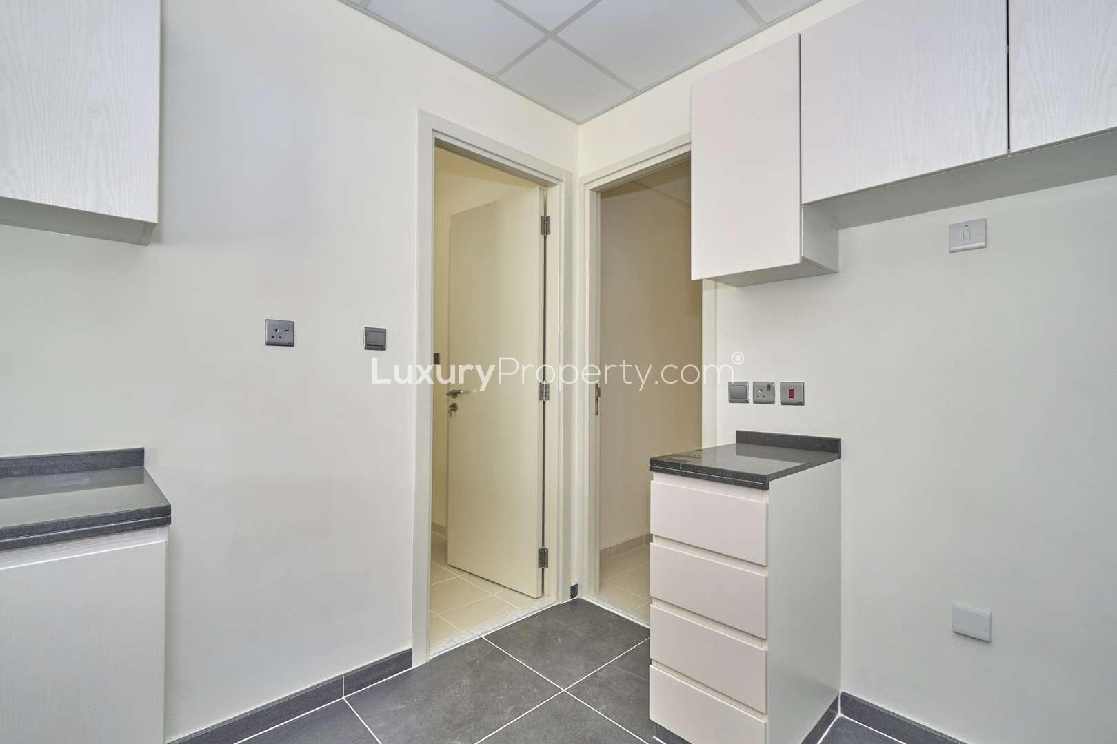 Modern kitchen in 4-bed townhouse, Aster, Akoya, featuring sleek countertops and ample cabinetry