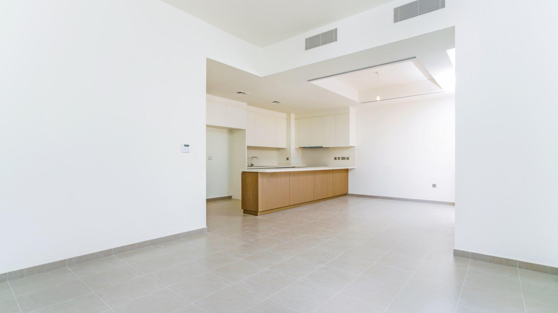 "Modern townhouse exterior with green lawn in Reem Community, Arabian Ranches 2, for sale.",Modern kitchen with island in 4-bed townhouse, Reem Community, Arabian Ranches 2