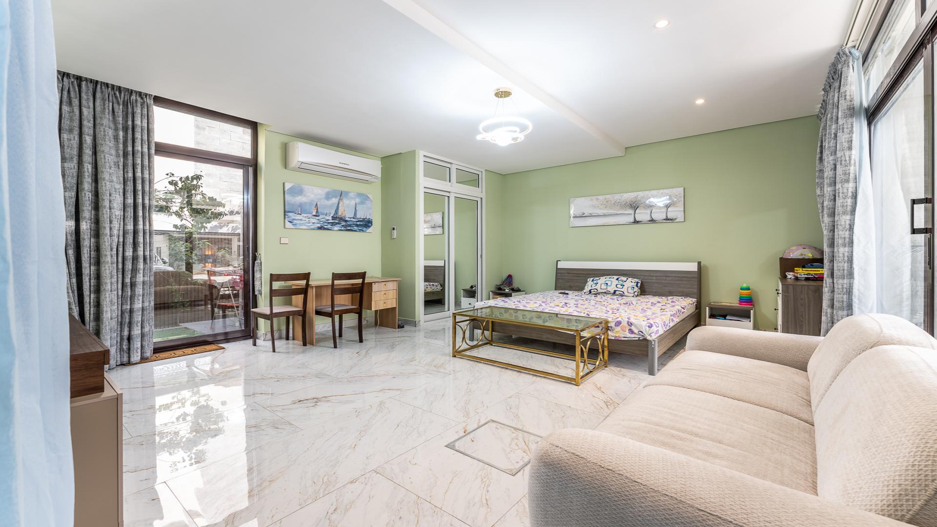 Upgraded bedroom in 4-bedroom villa, Trevi, Damac Hills, featuring modern decor and large windows