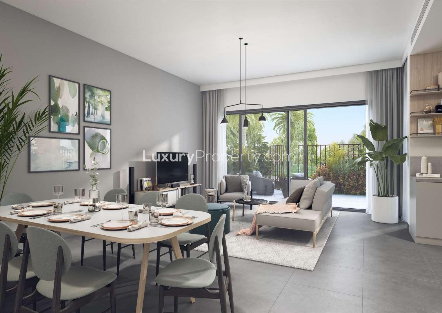 Modern townhouse interior with dining area, living room, and garden view in Arabian Ranches 3