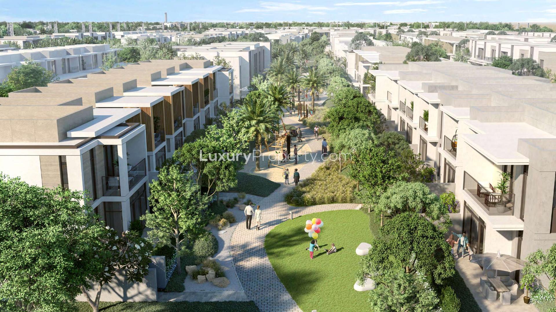 Alt text: "Scenic view of landscaped path in Arabian Ranches 3, Ruba community townhouse area.",Aerial view of modern townhouses in lush Arabian Ranches 3, Ruba community, Dubai