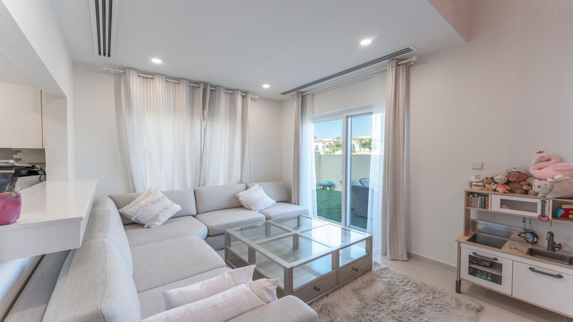 Outdoor patio with seating in single-row townhouse, Villanova, Dubai Land