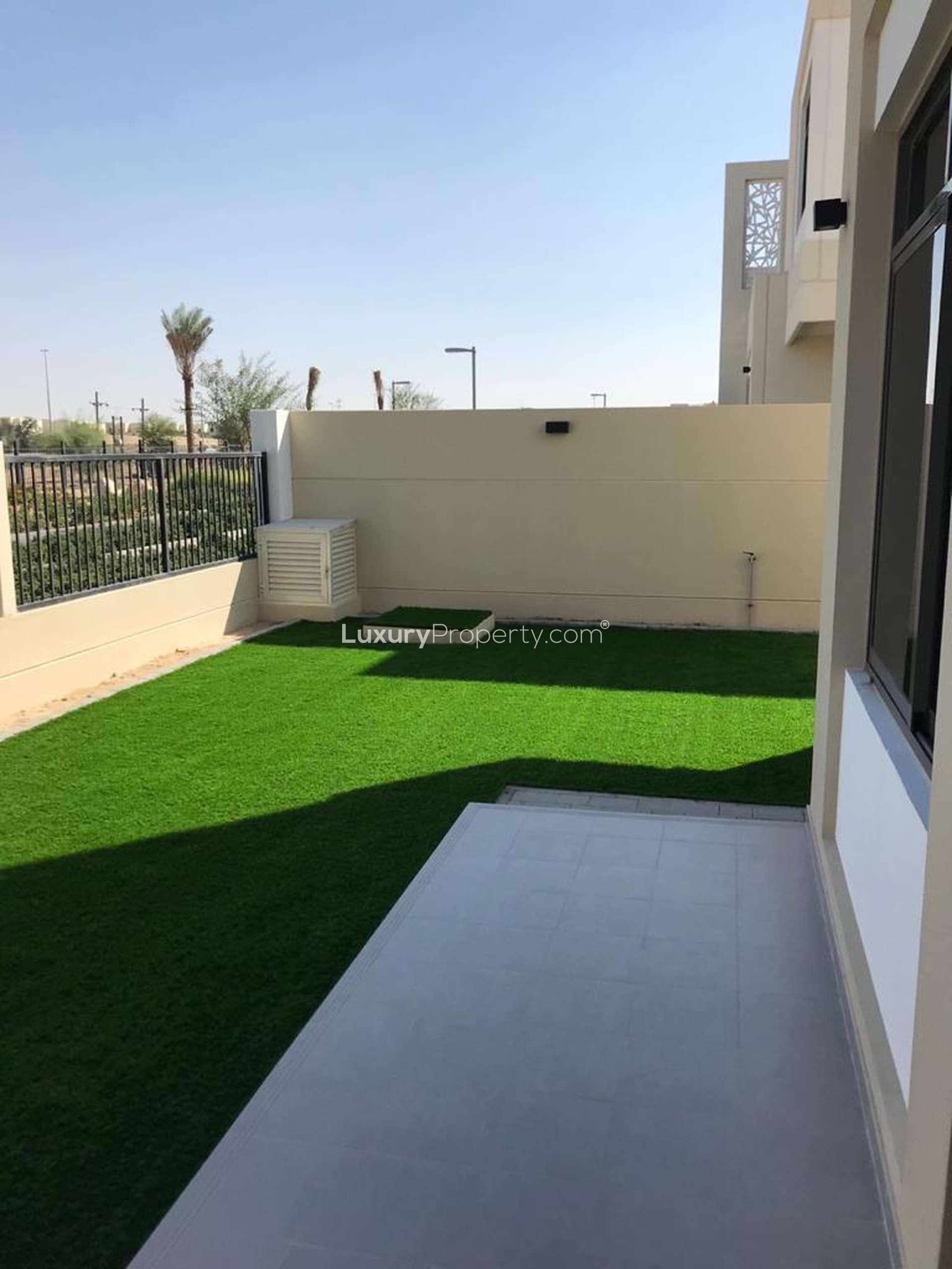 Town Square Dubai townhouse backyard with lawn and patio in Safi community