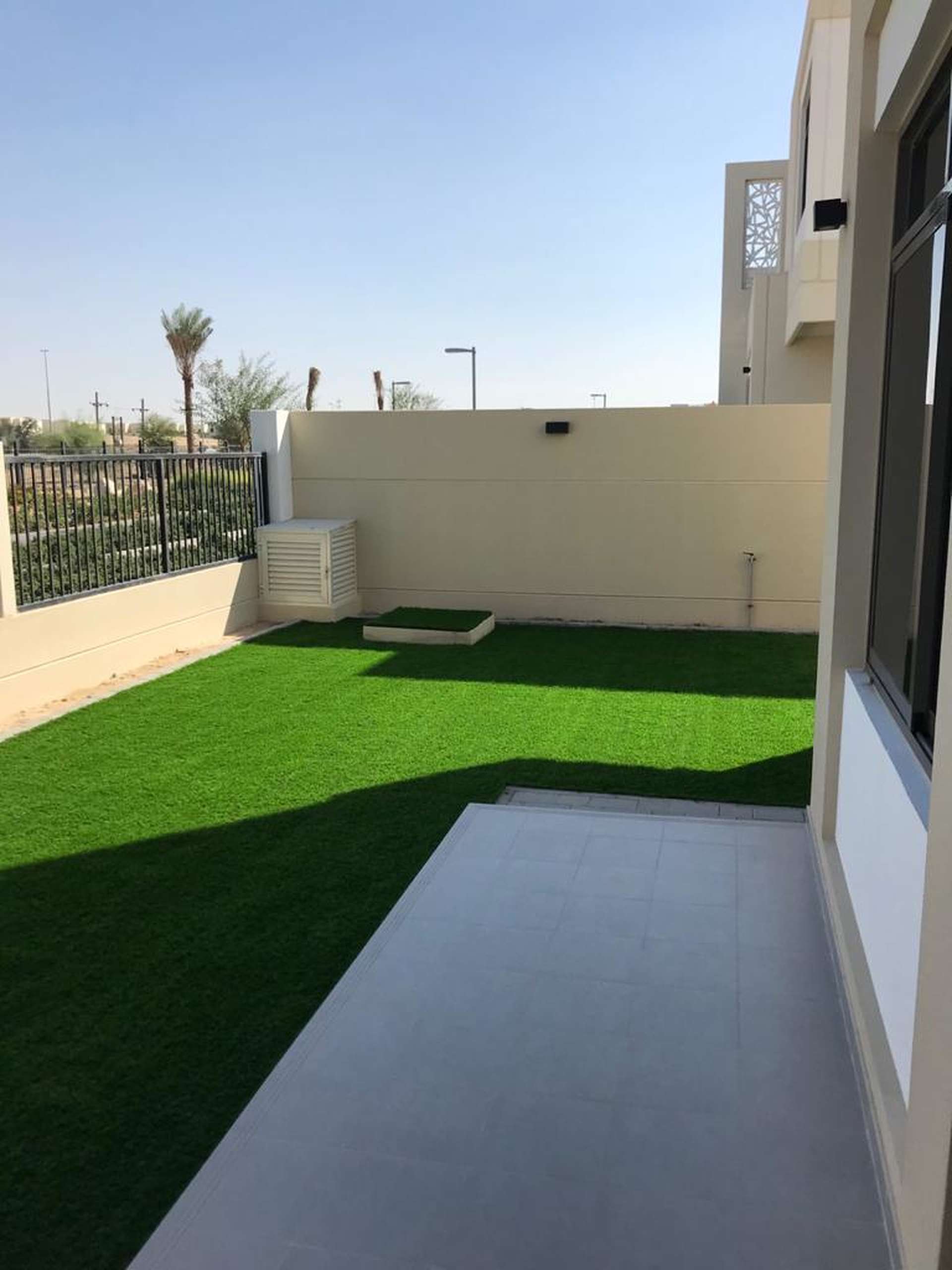Town Square Dubai townhouse backyard with lawn and patio in Safi community