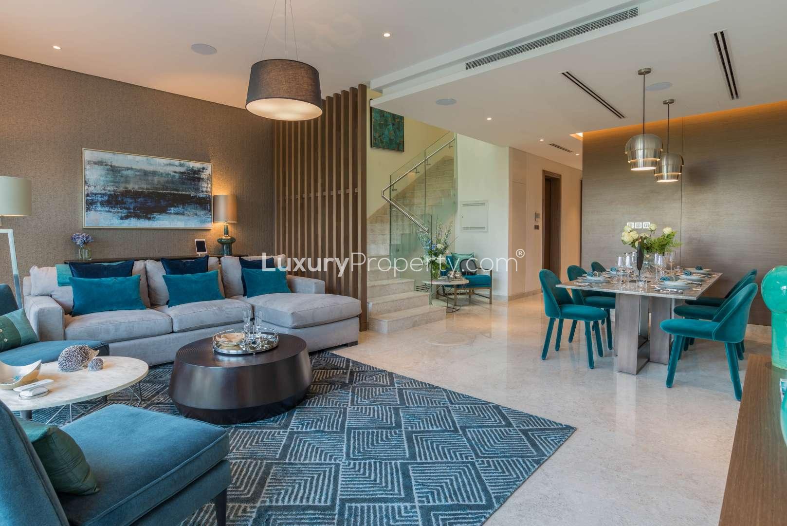 "Elegant living room view in Sobha Hartland townhouse, MBR City, for sale.",Elegant living and dining area in Sobha Hartland townhouse, MBR City