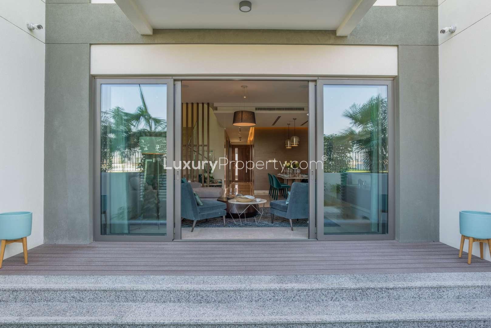 Elegant dining area in Sobha Hartland townhouse, featuring modern decor and natural lighting