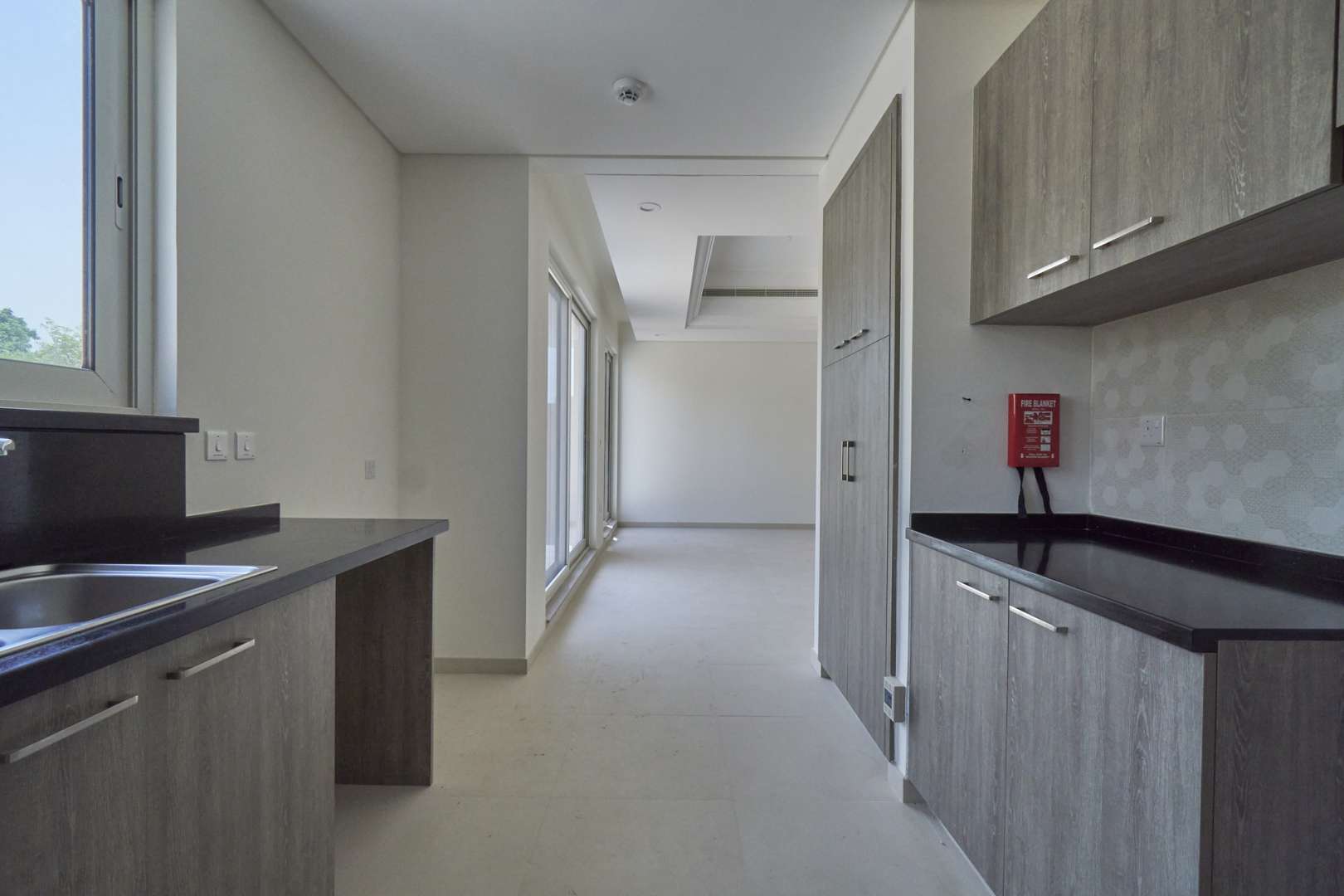 Modern kitchen in Marbella townhouse, Dubai Sports City, featuring sleek cabinetry and countertops