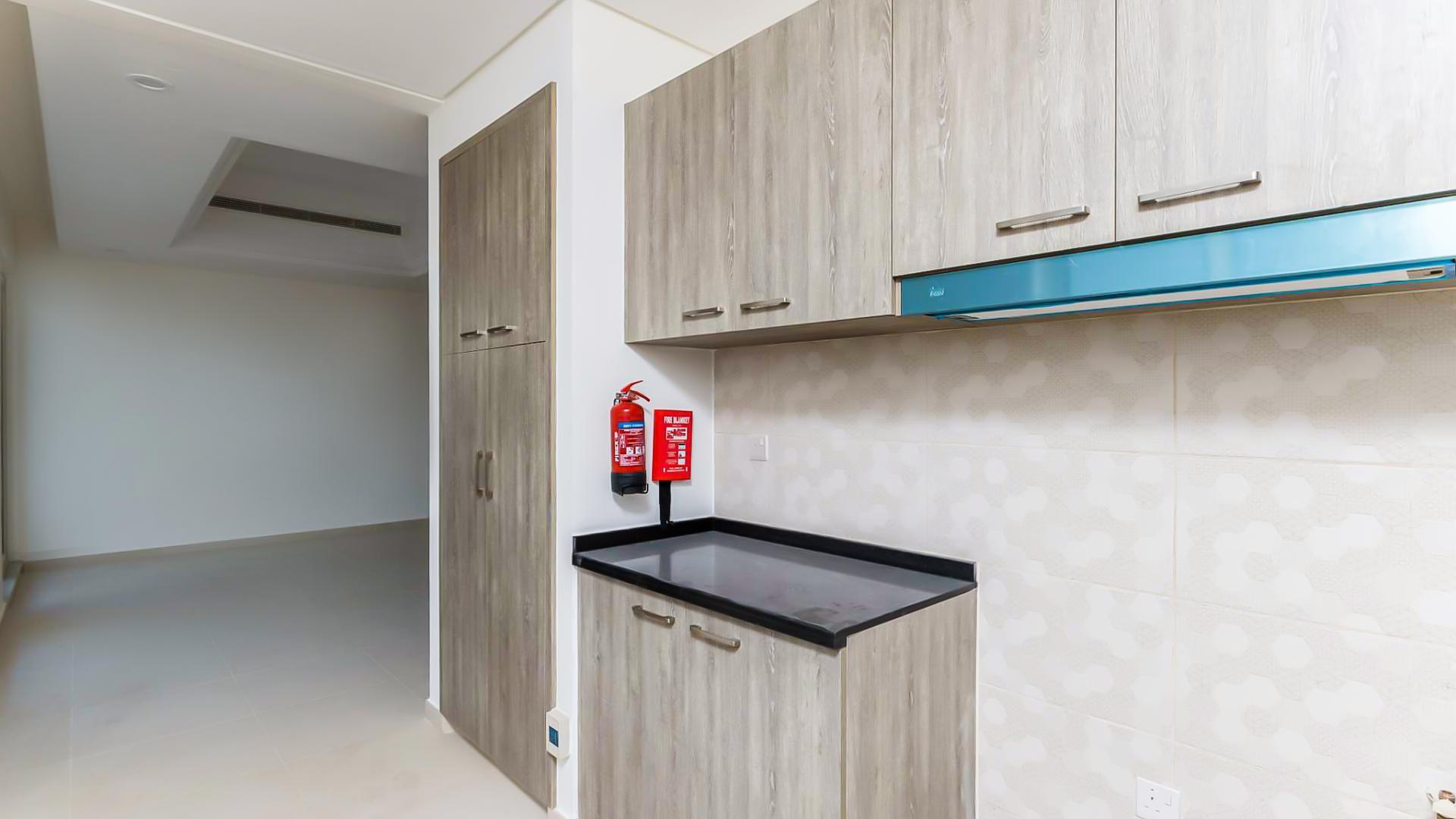 Modern kitchen cabinetry in four-bedroom townhouse, Victory Heights, Dubai Sports City, for sale