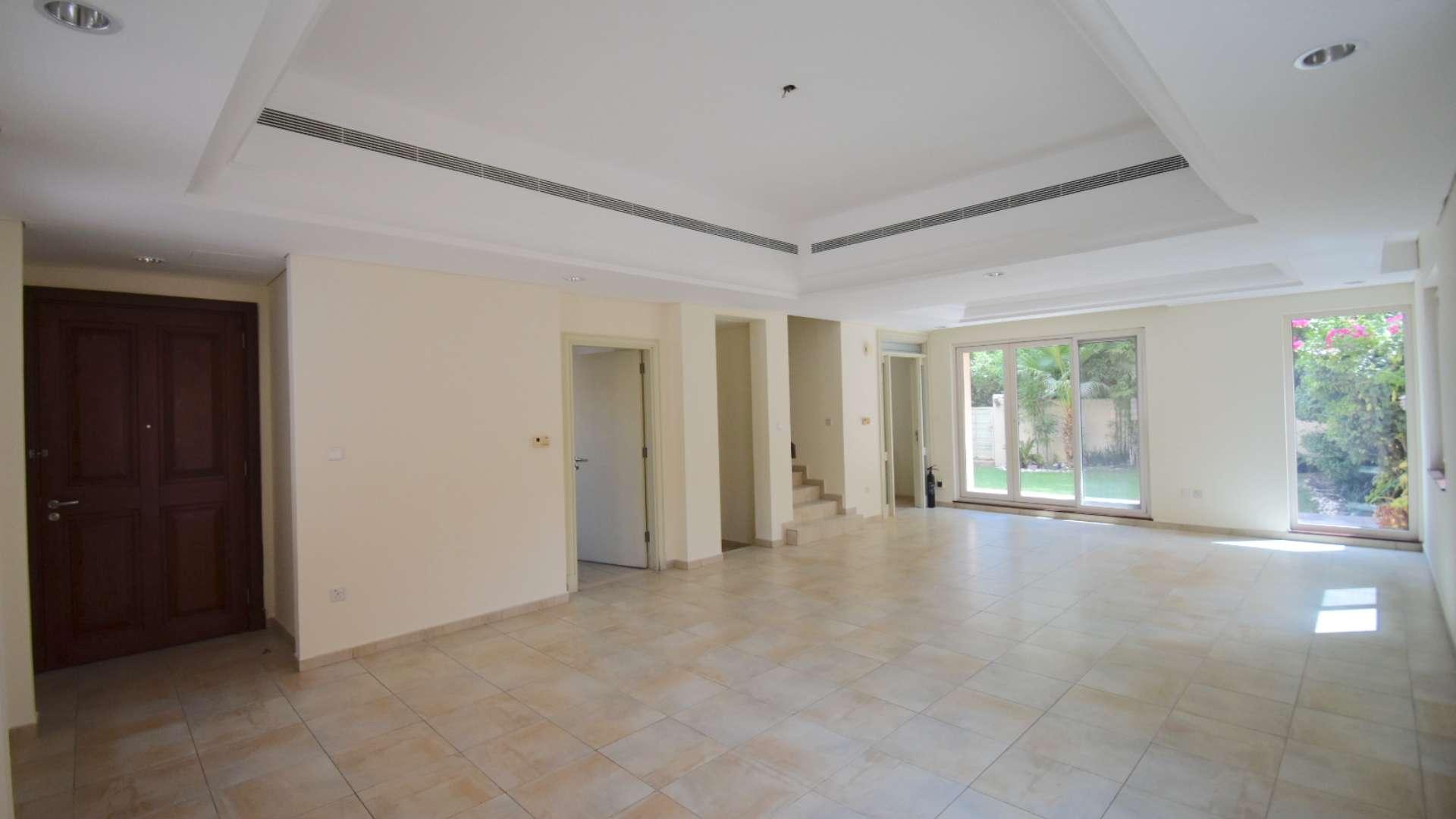Spacious townhouse backyard with artificial grass and outdoor seating in Victory Heights, Dubai Sports City