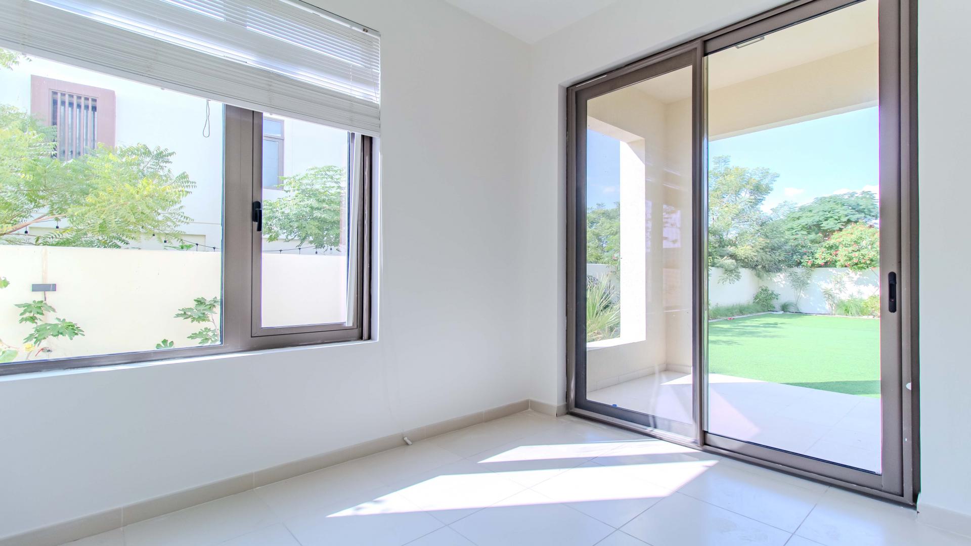Bright interior of 3-bed townhouse in Mira Oasis, featuring modern staircase and large windows
